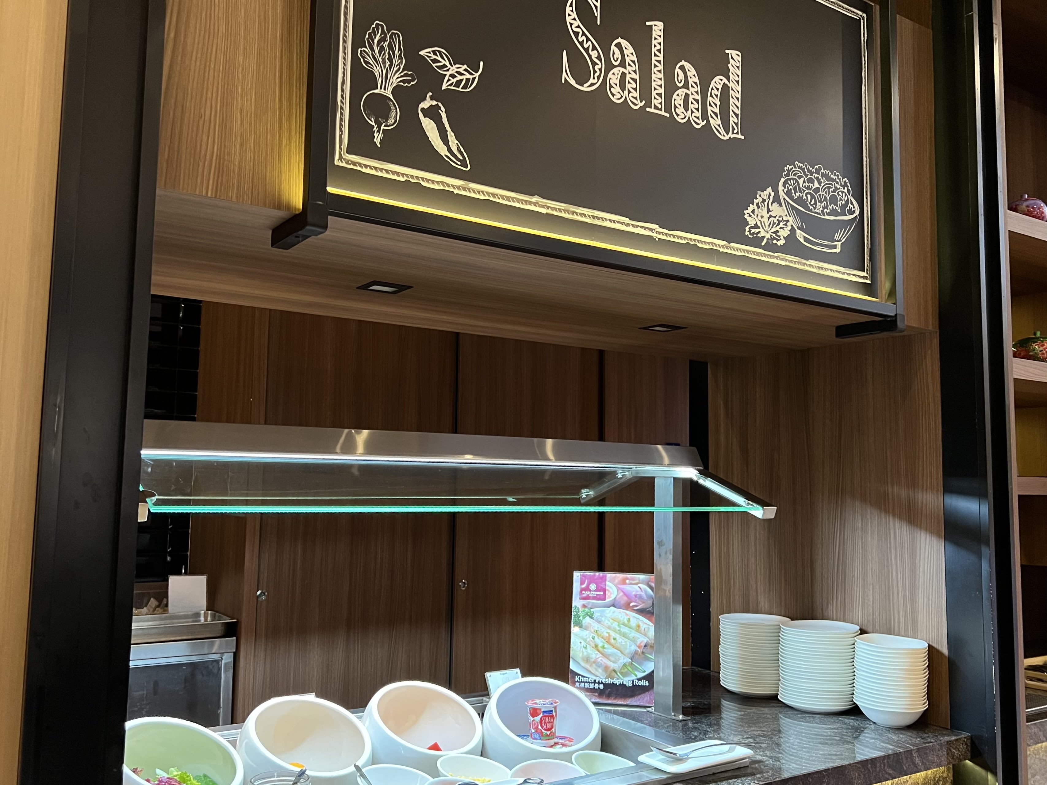 a salad bar with a sign above it
