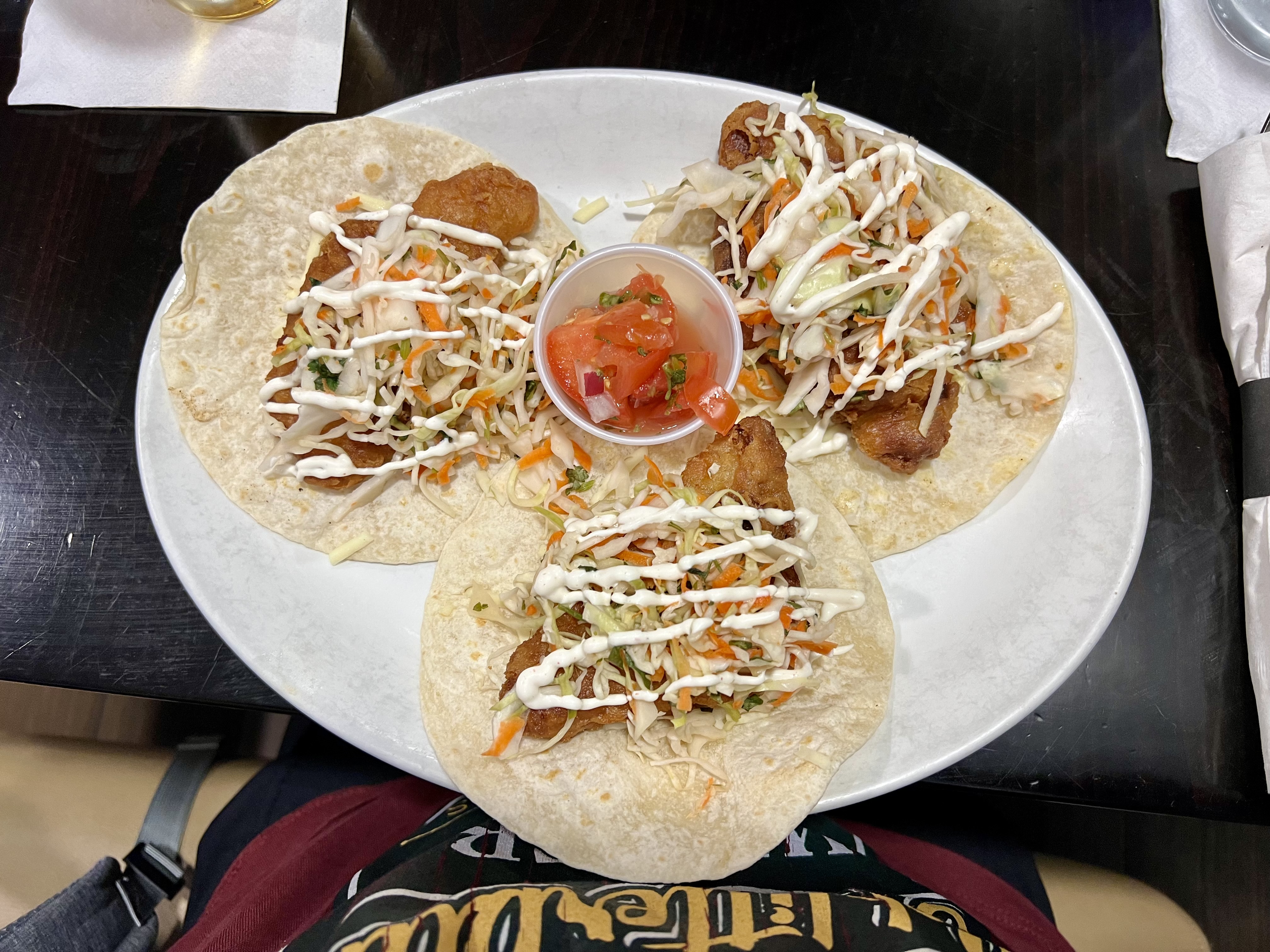 a plate of tacos with sauce