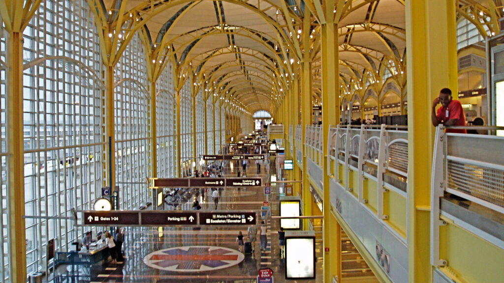 a large yellow building with many people walking