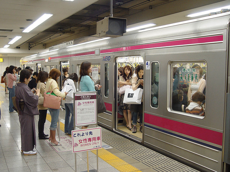 a group of people boarding a train