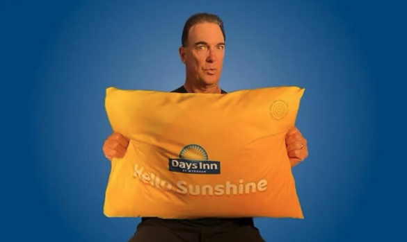 a man holding a yellow pillow