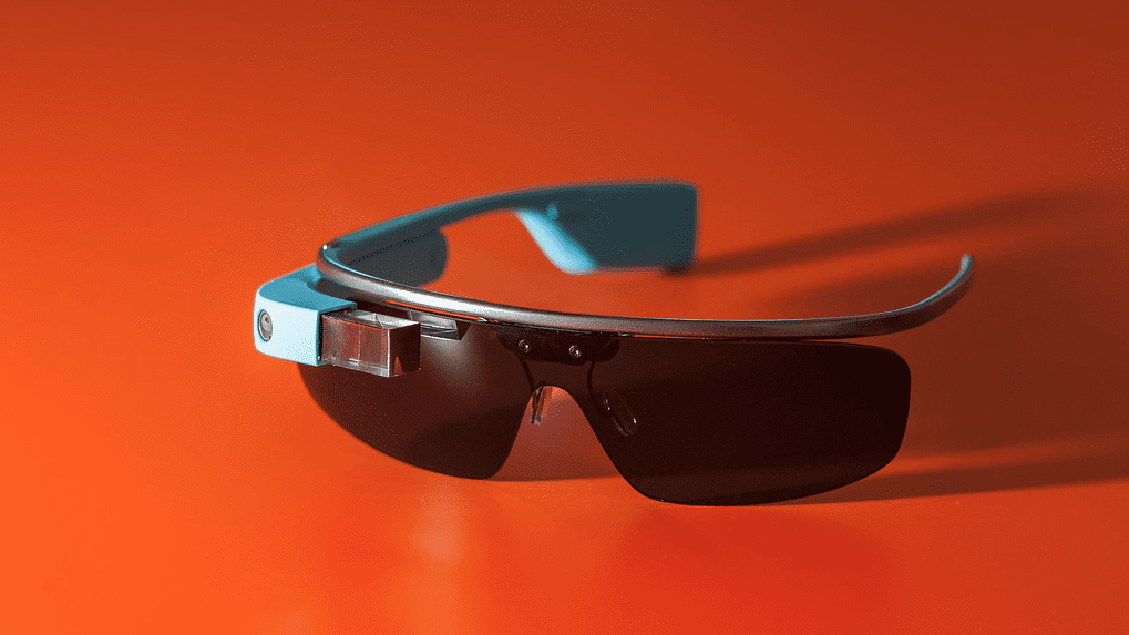 a pair of sunglasses on an orange surface