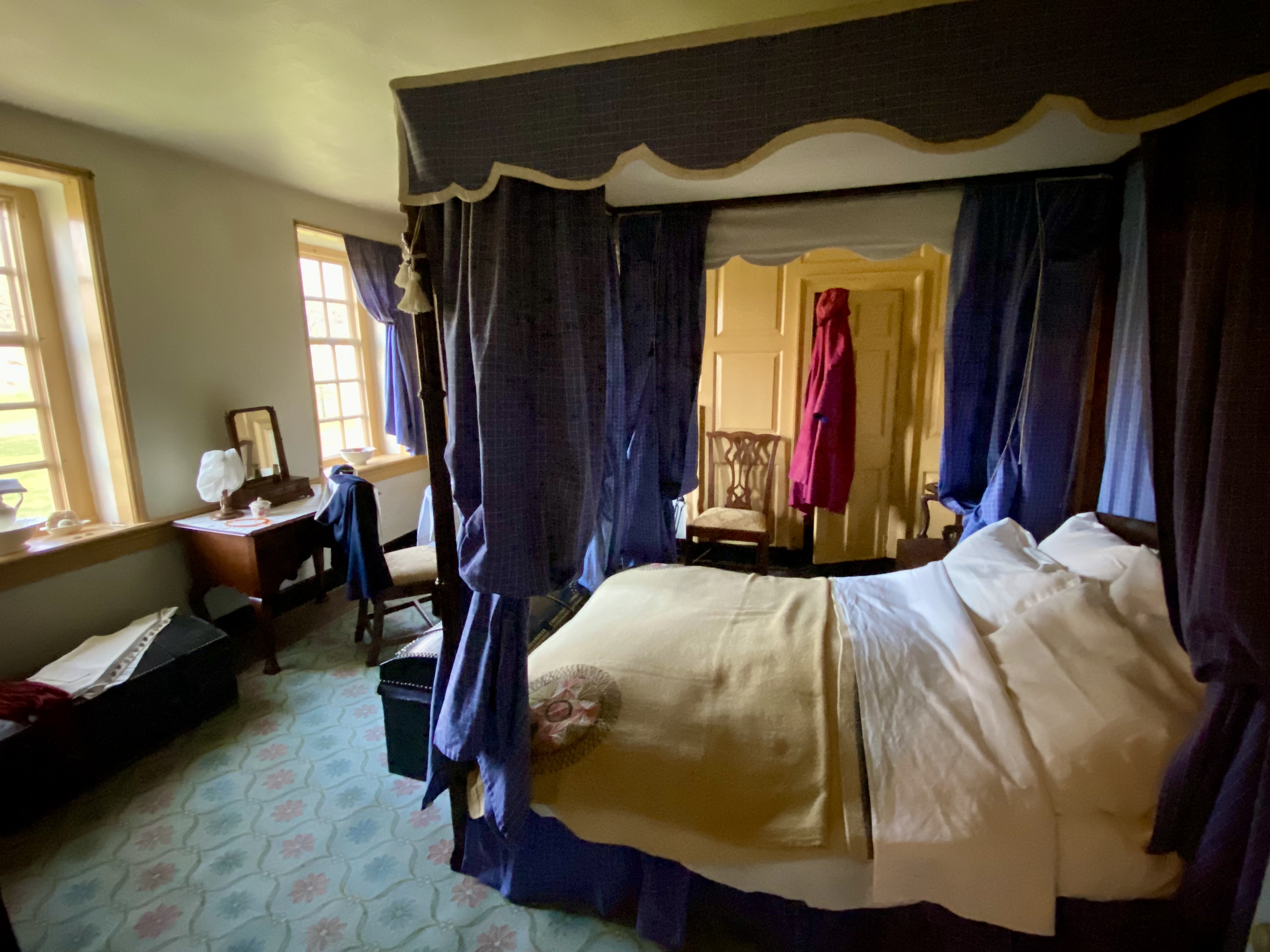 a bed with purple curtains in a room