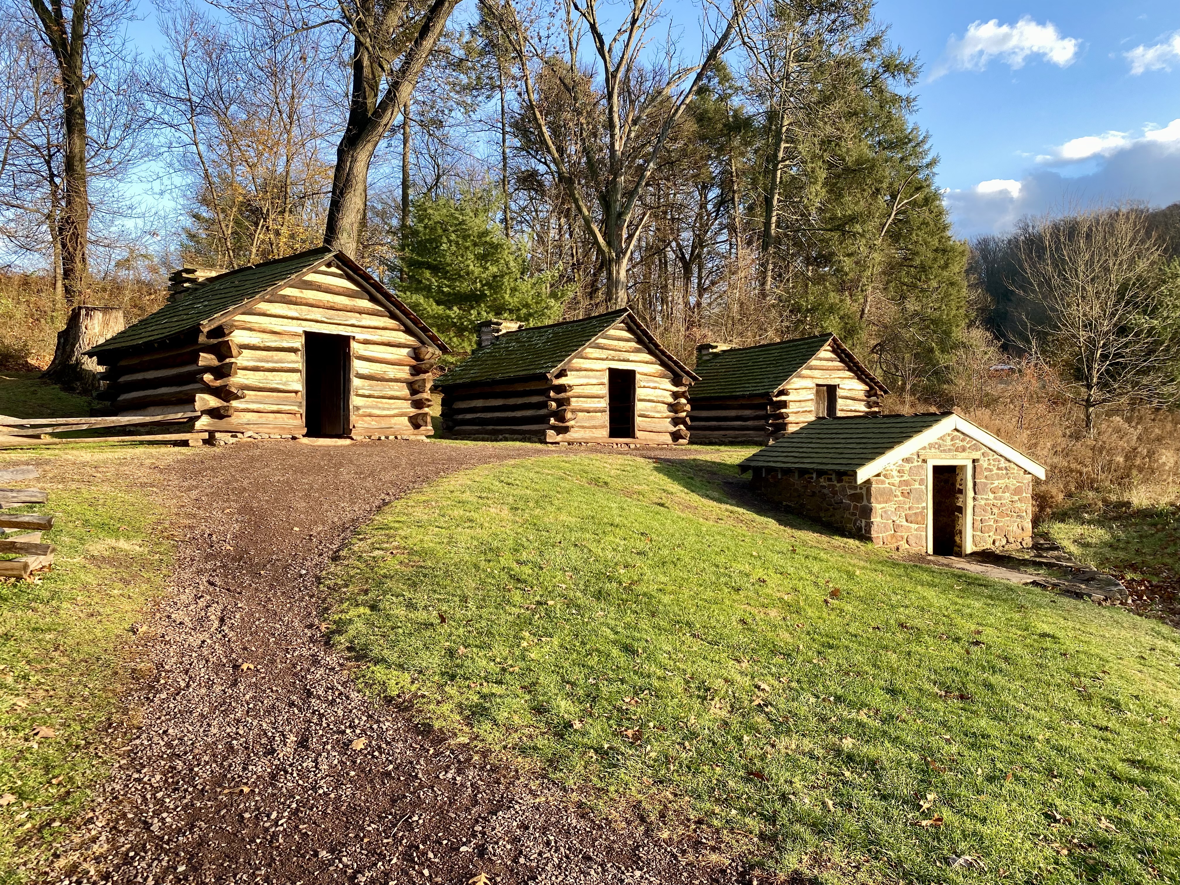 a group of log cabins on a hill