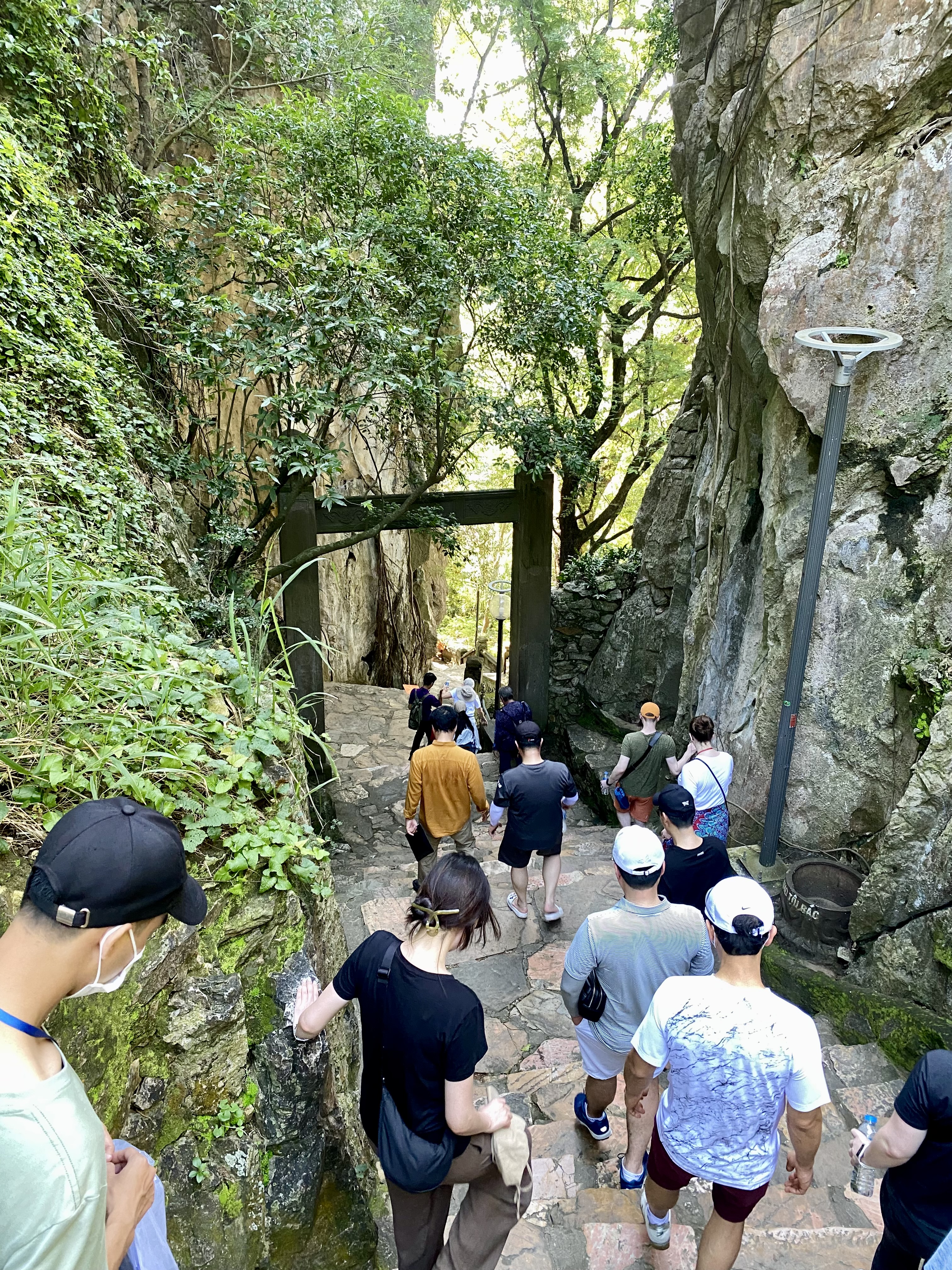 a group of people walking down a path in a rocky area