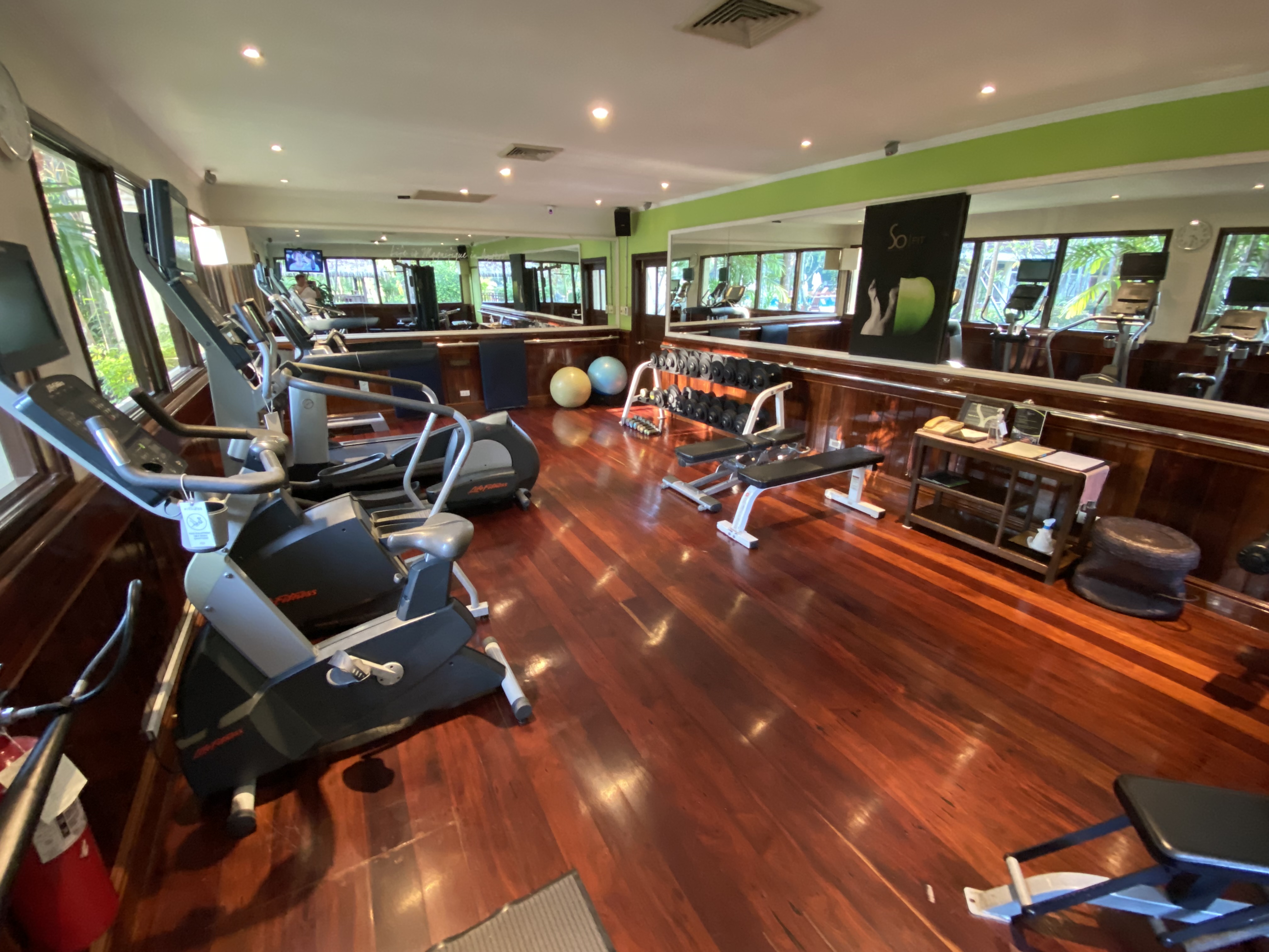 a room with exercise equipment and a mirror