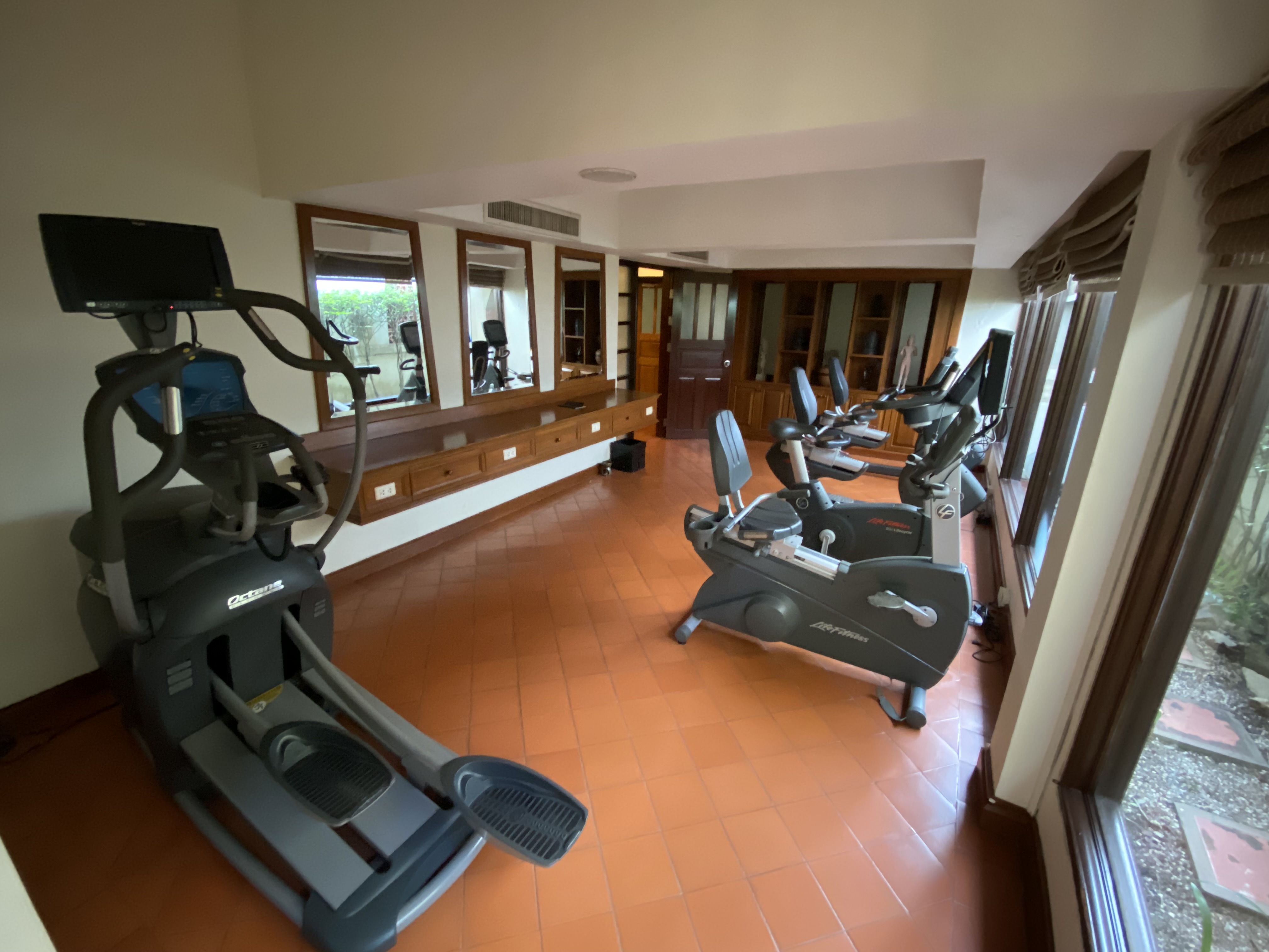 a room with exercise machines and a mirror