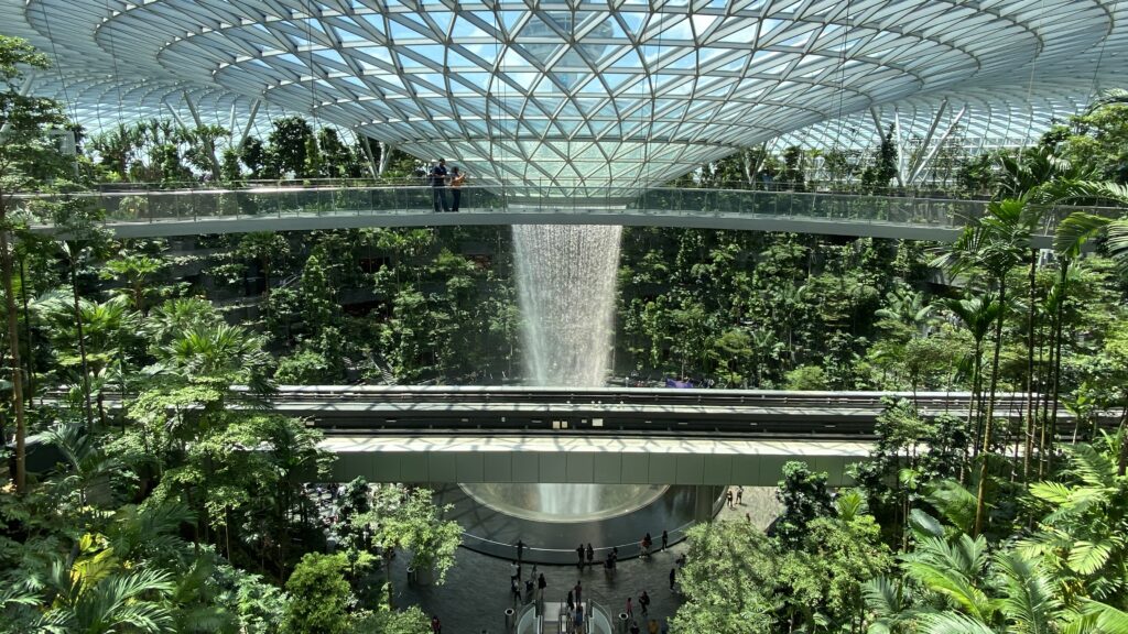 a glass dome with a waterfall in the middle