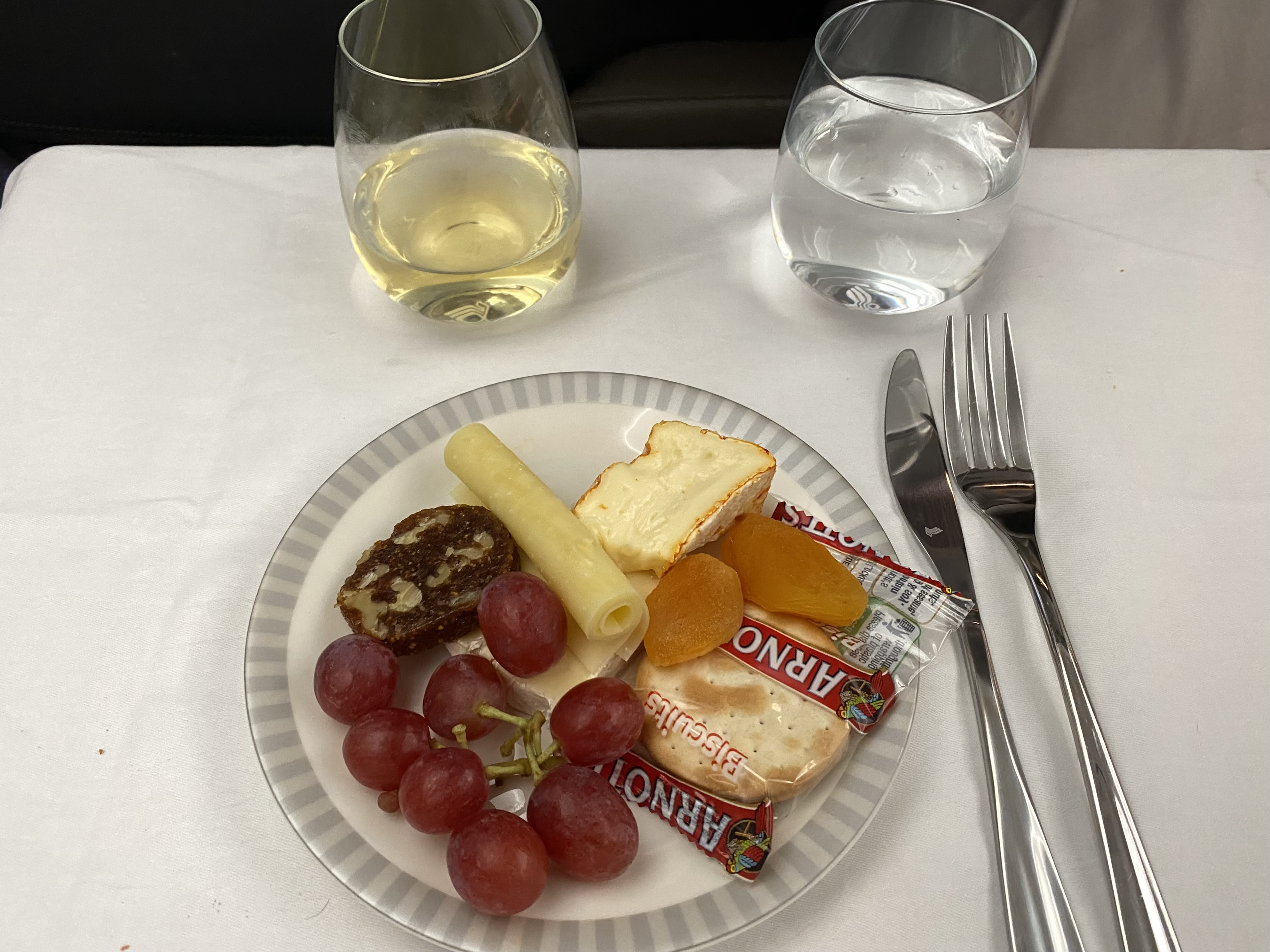 a plate of food and wine on a table