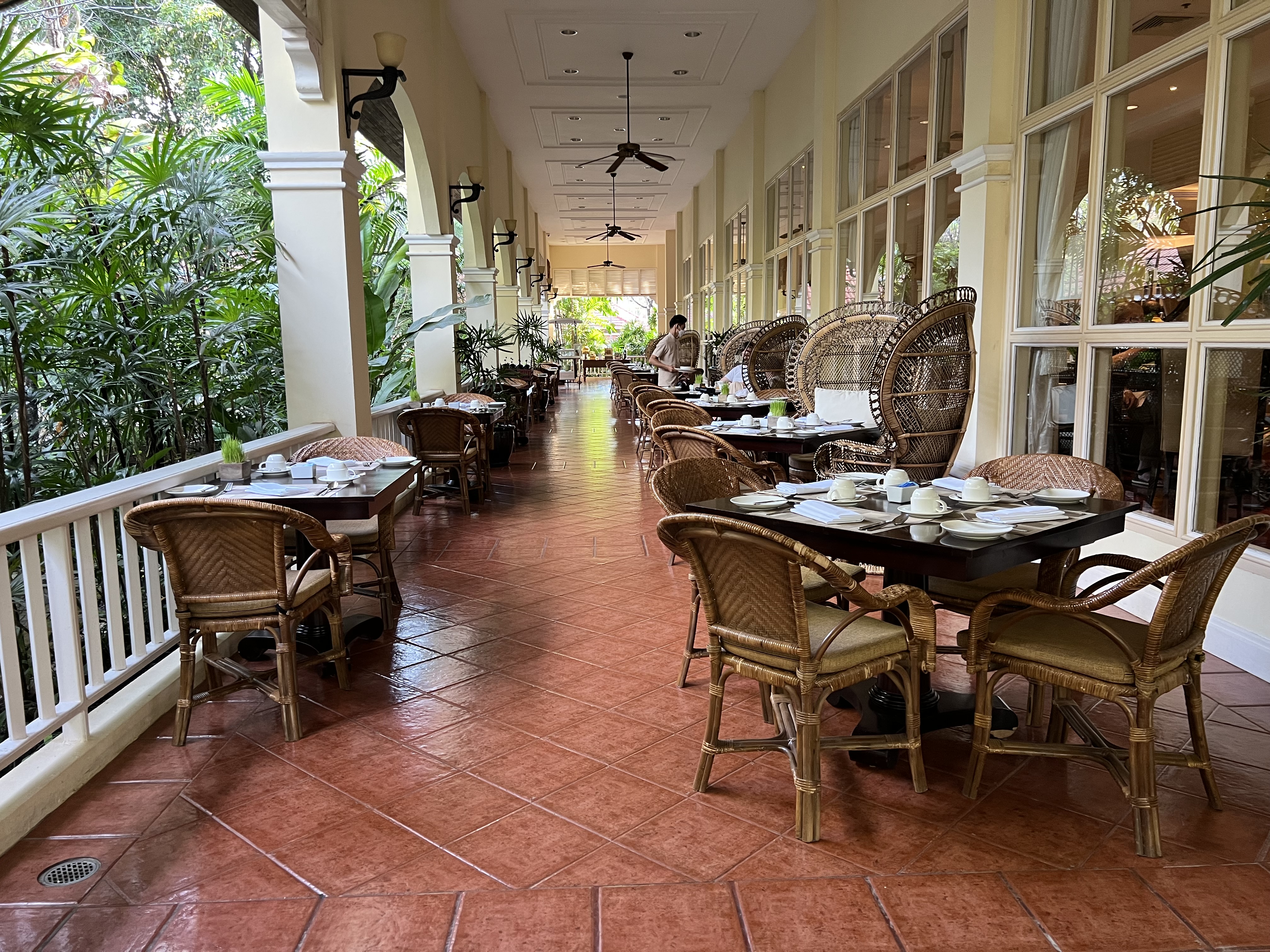 a long hallway with tables and chairs