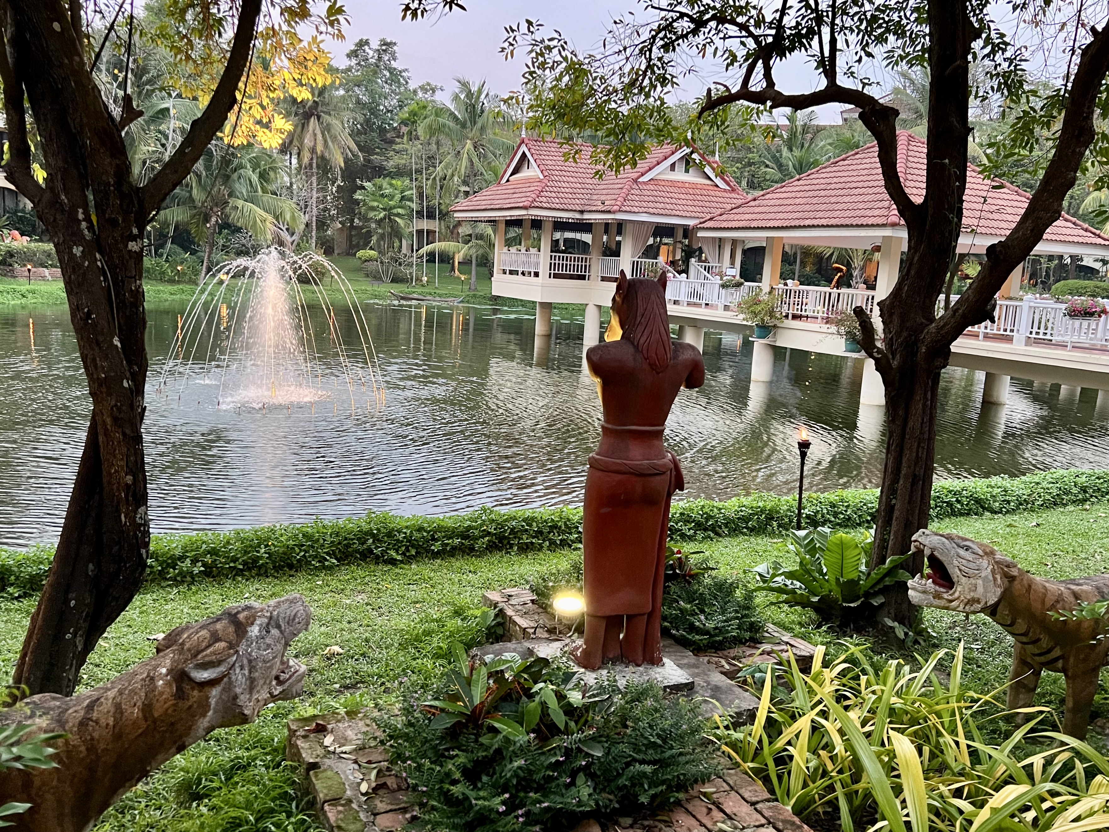 a statue in front of a water fountain