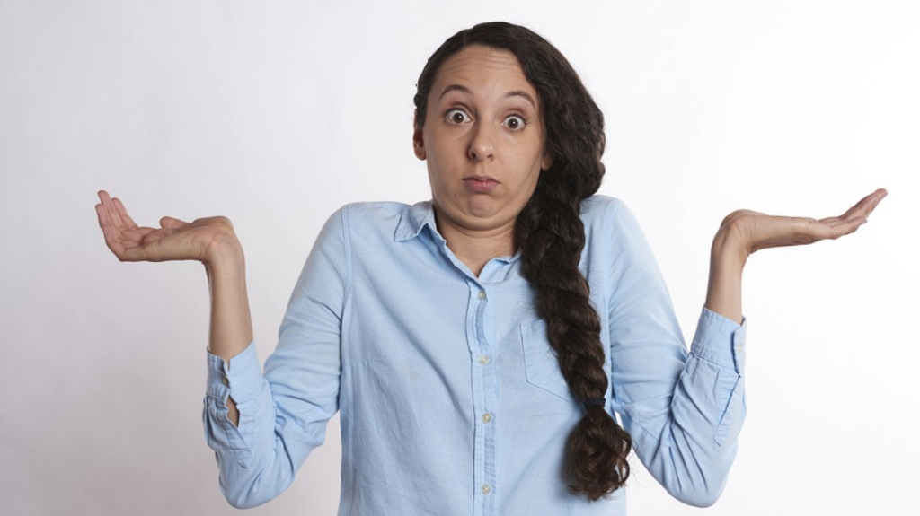 a woman with long hair making a face with her hands