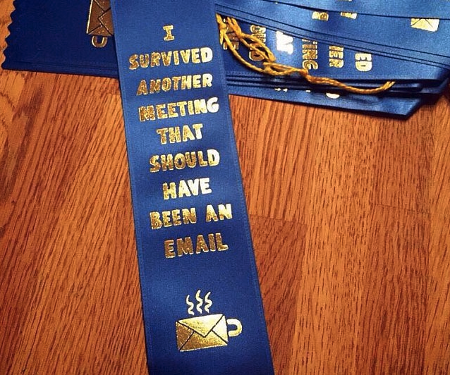 a blue ribbon with gold text on it