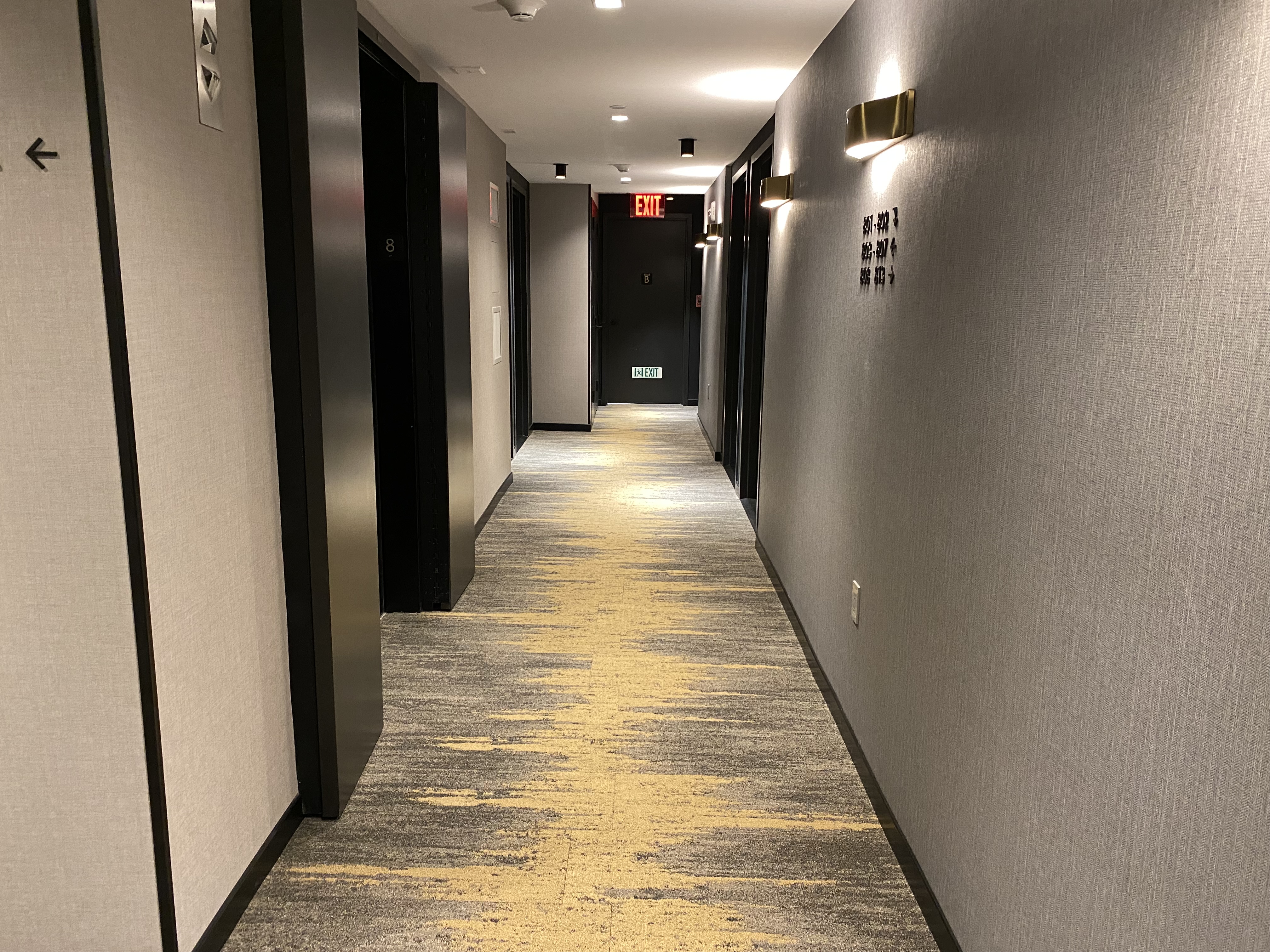 a hallway with doors and signs