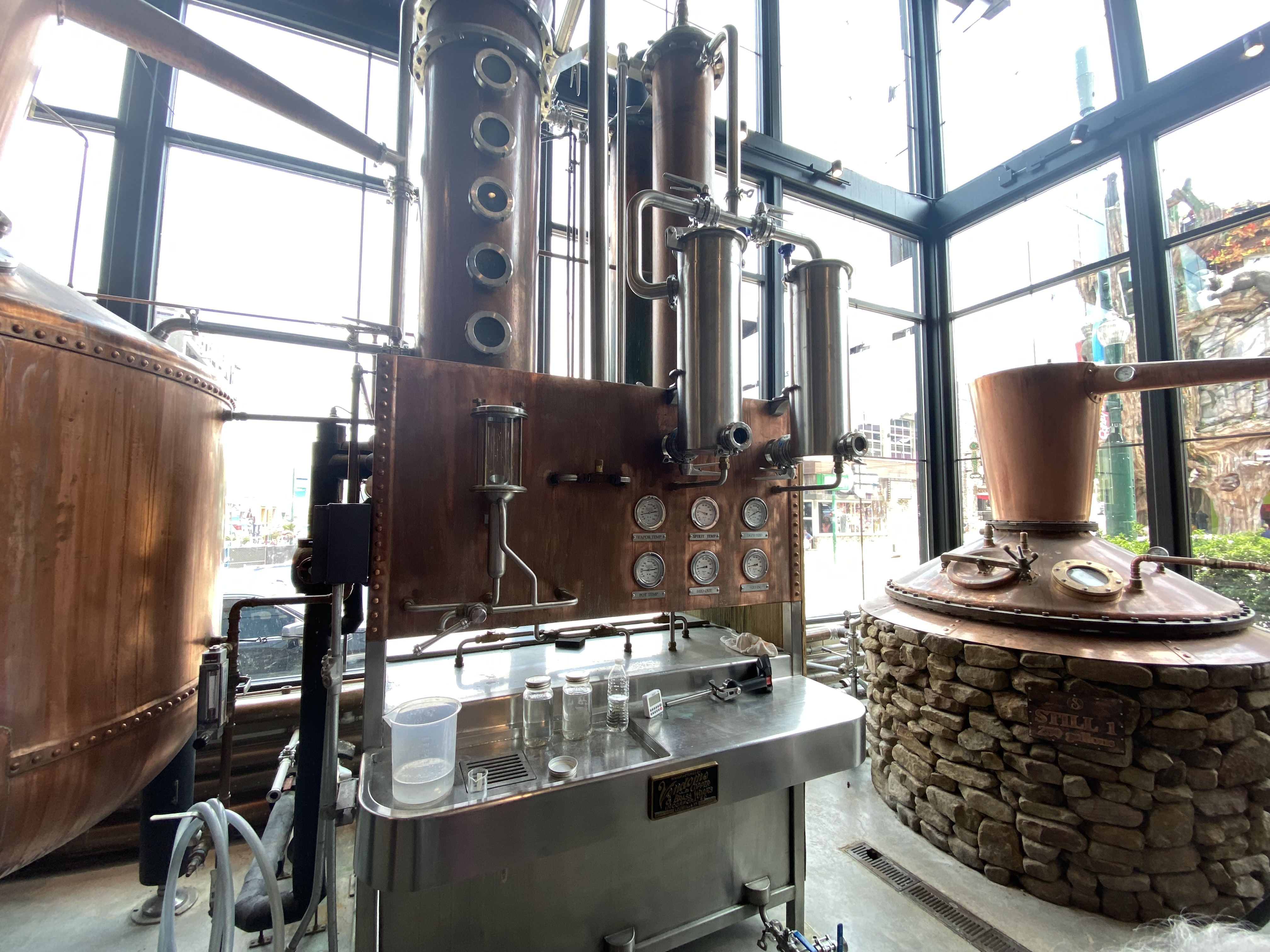 a large metal machine with pipes and a large glass window