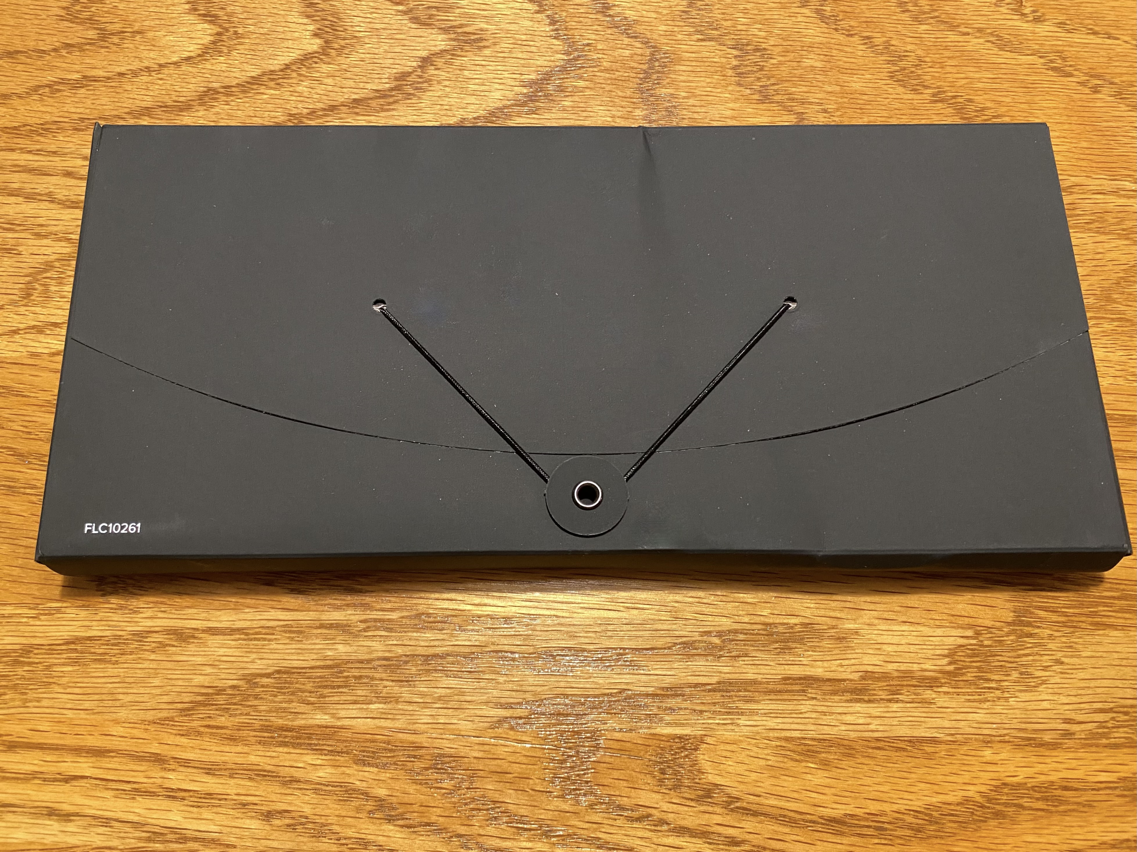 a black envelope with a hole in it