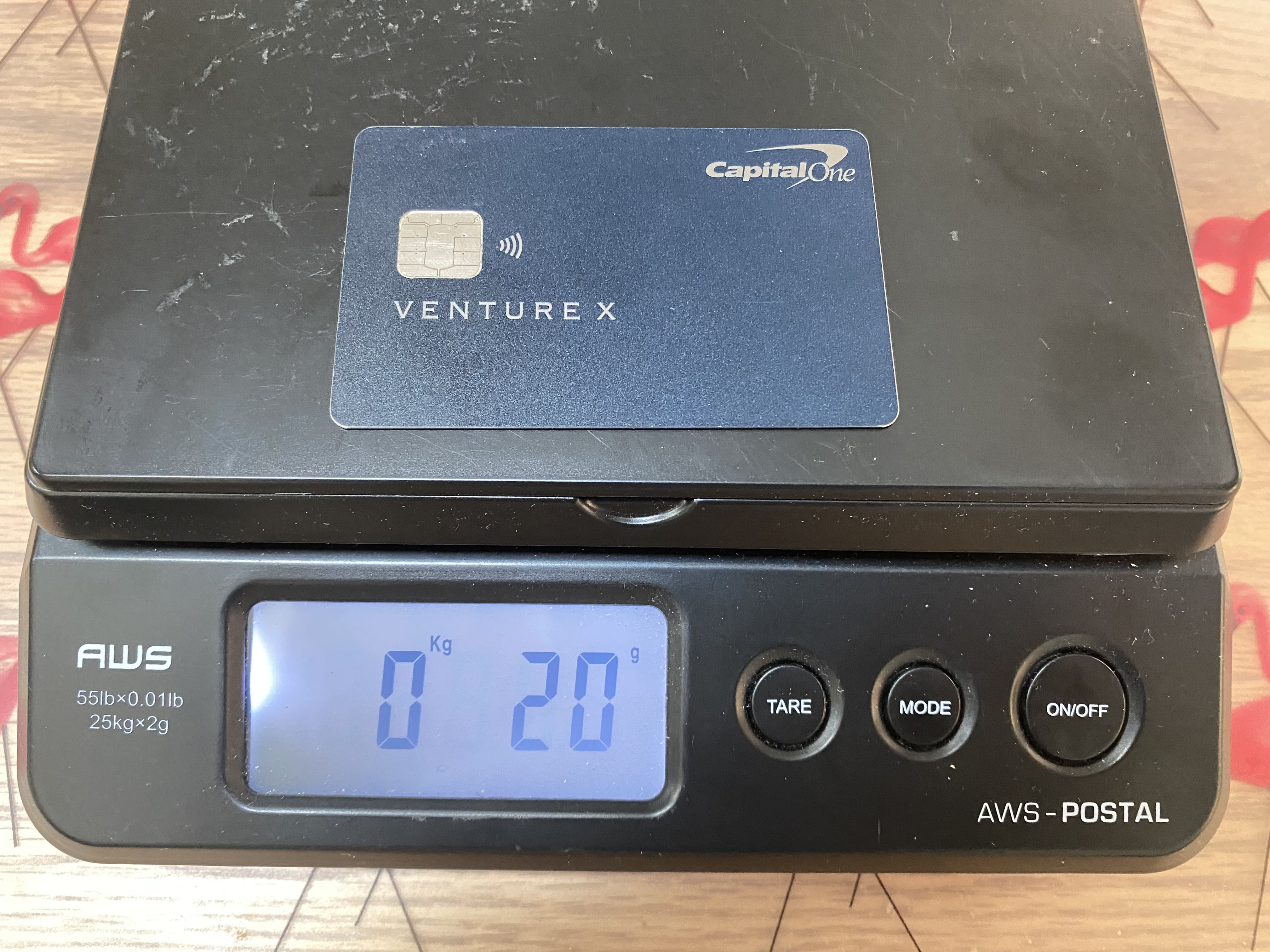 a black electronic scale with a credit card on it