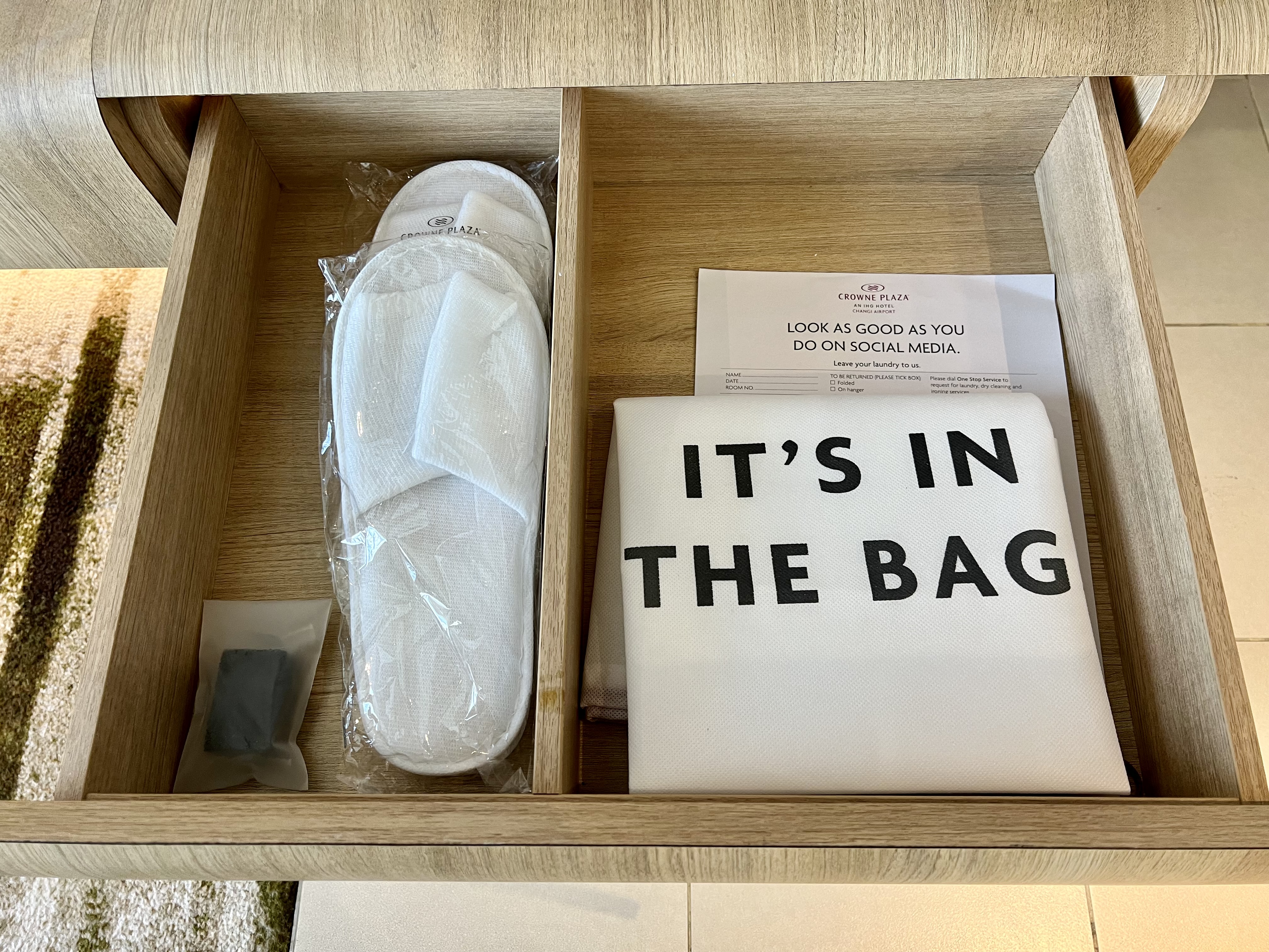 a wooden box with a pair of slippers and a white towel