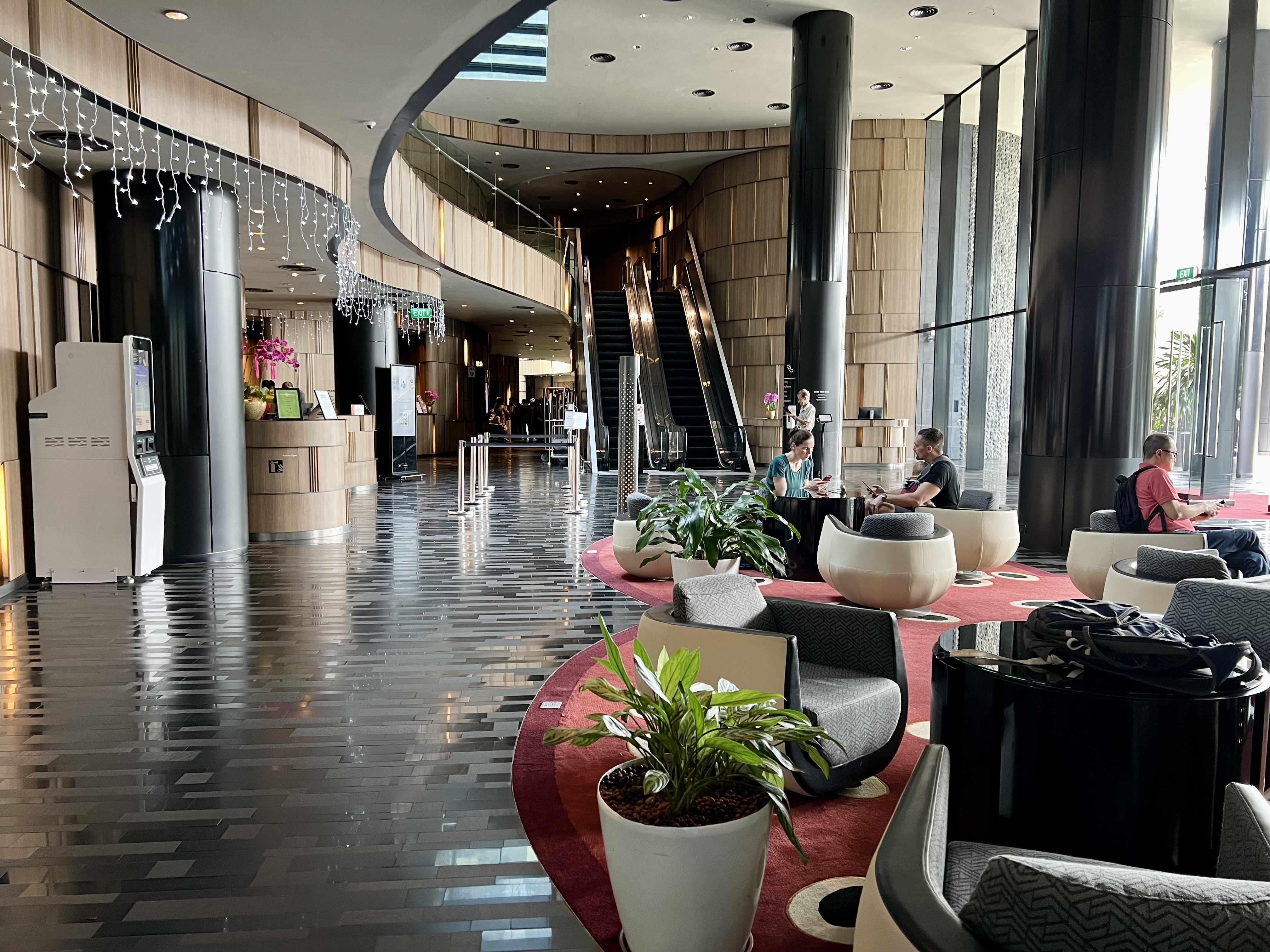 a large lobby with a large staircase and chairs