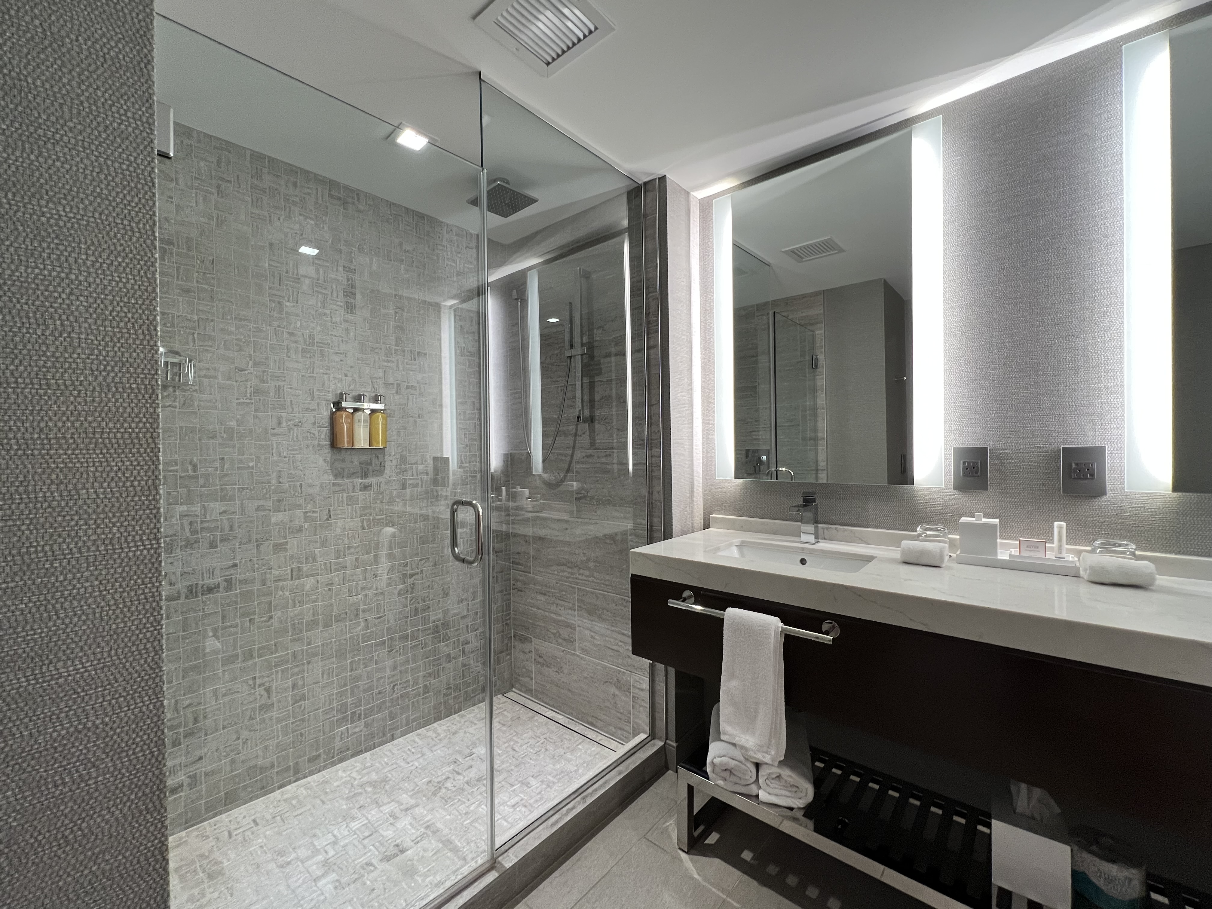 a bathroom with a glass shower and sink