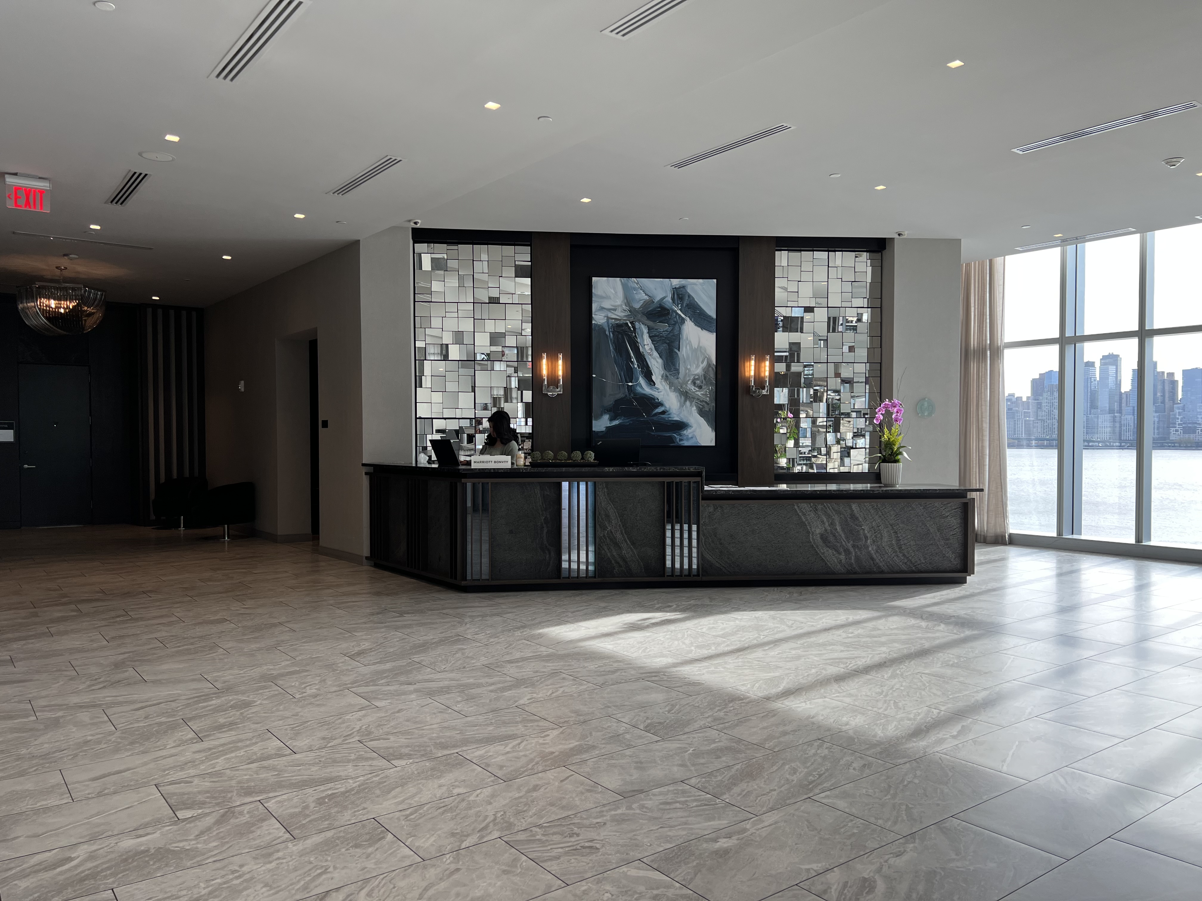 a lobby with a large mirror wall and a large window