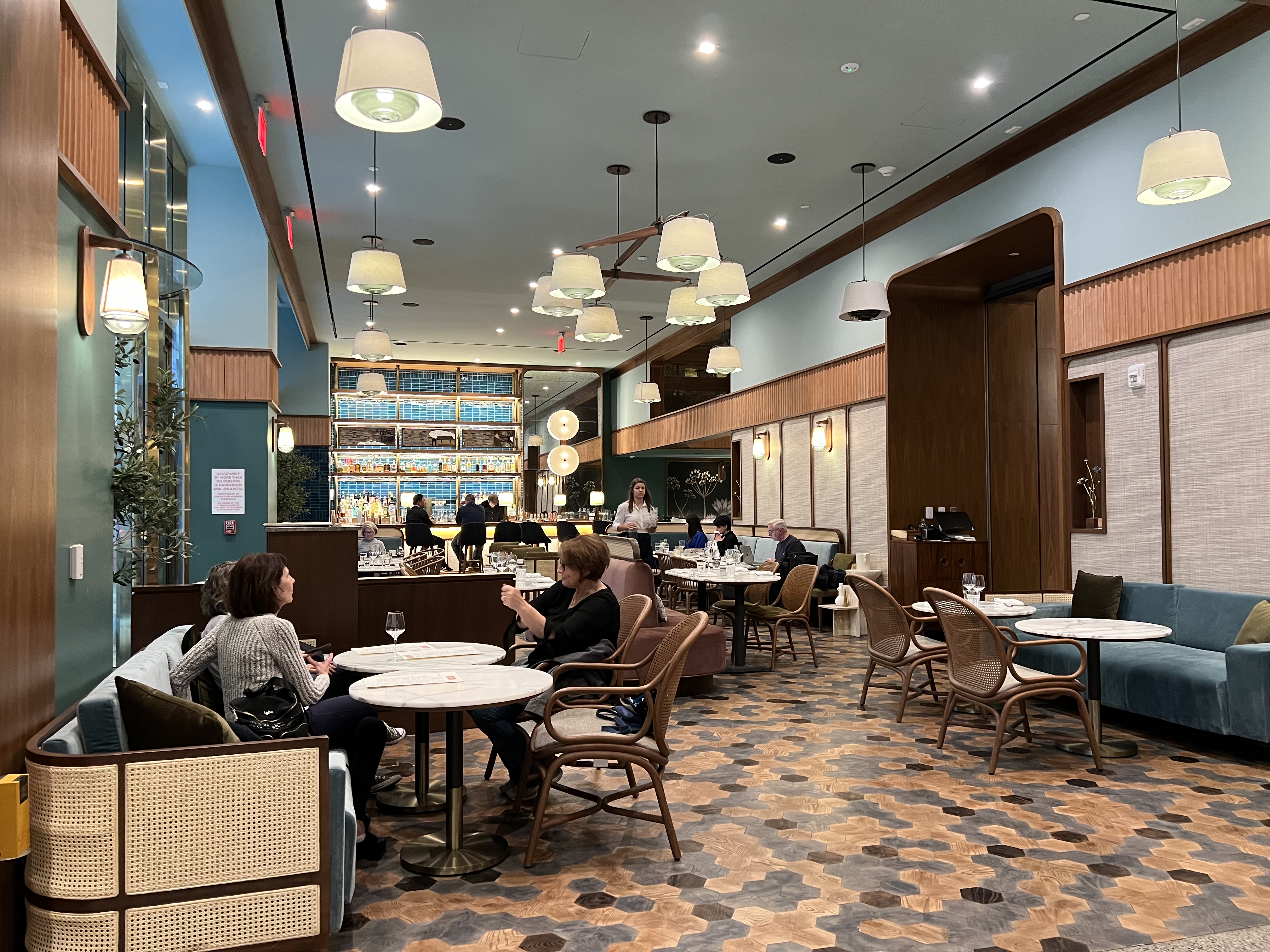 a group of people sitting at tables in a restaurant