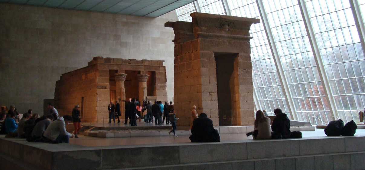 people standing in a museum with a group of people