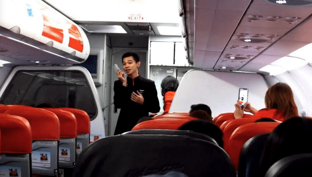 a boy talking on a phone in an airplane