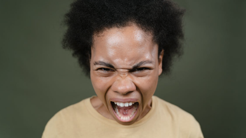 a person with afro hair making a face for the camera