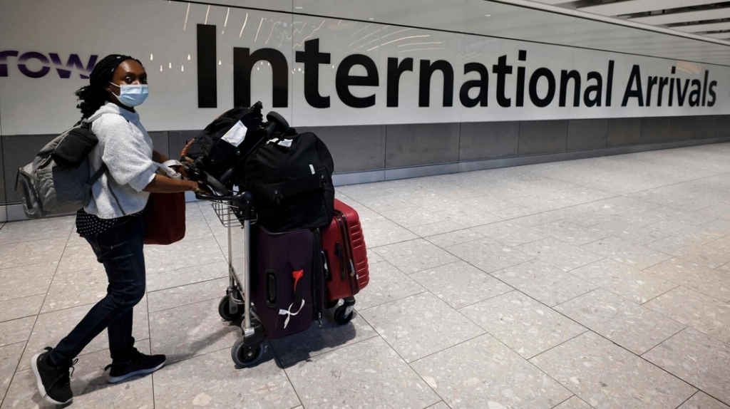 a luggage cart with luggage on it