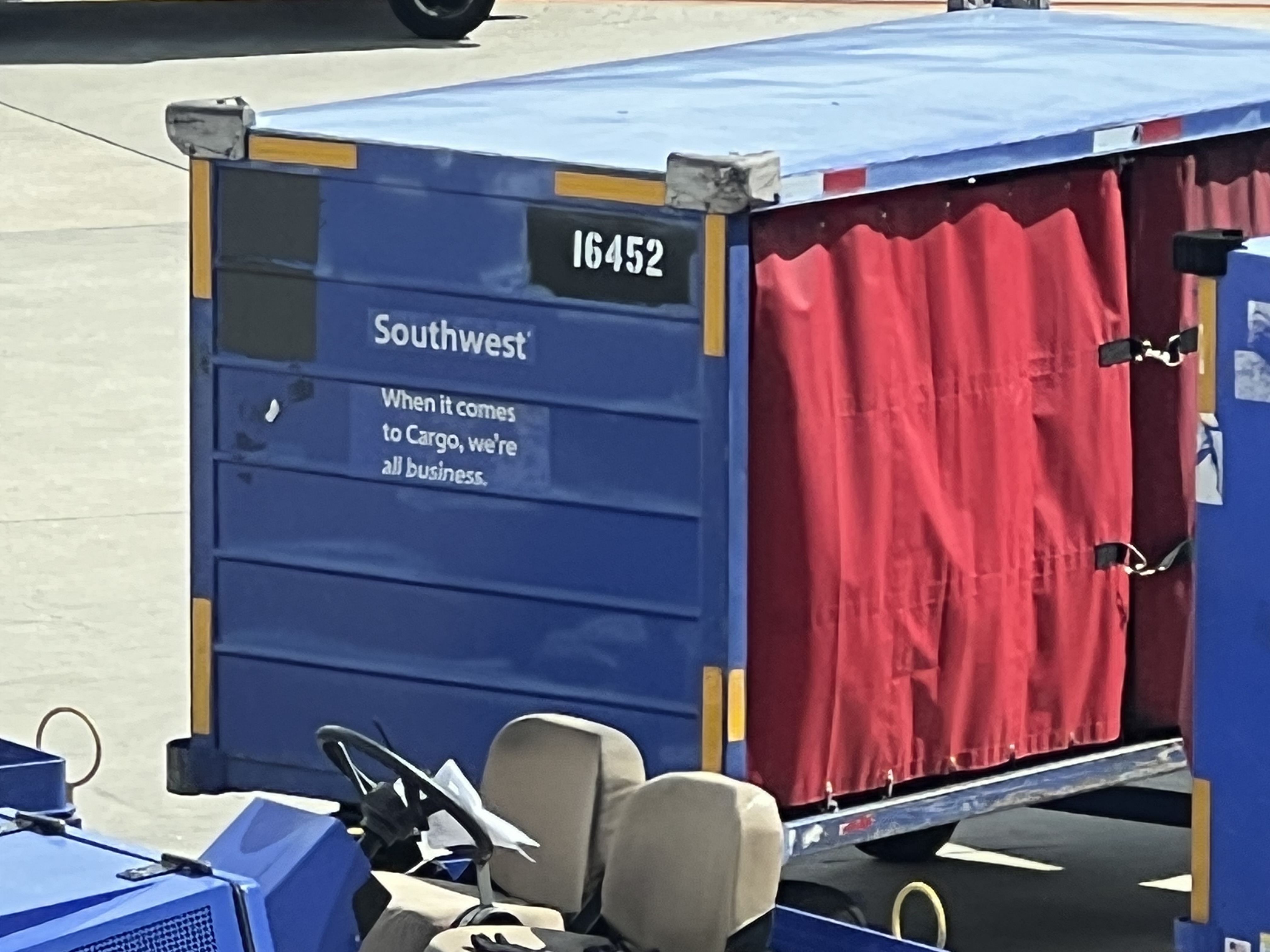 a blue container with a red curtain