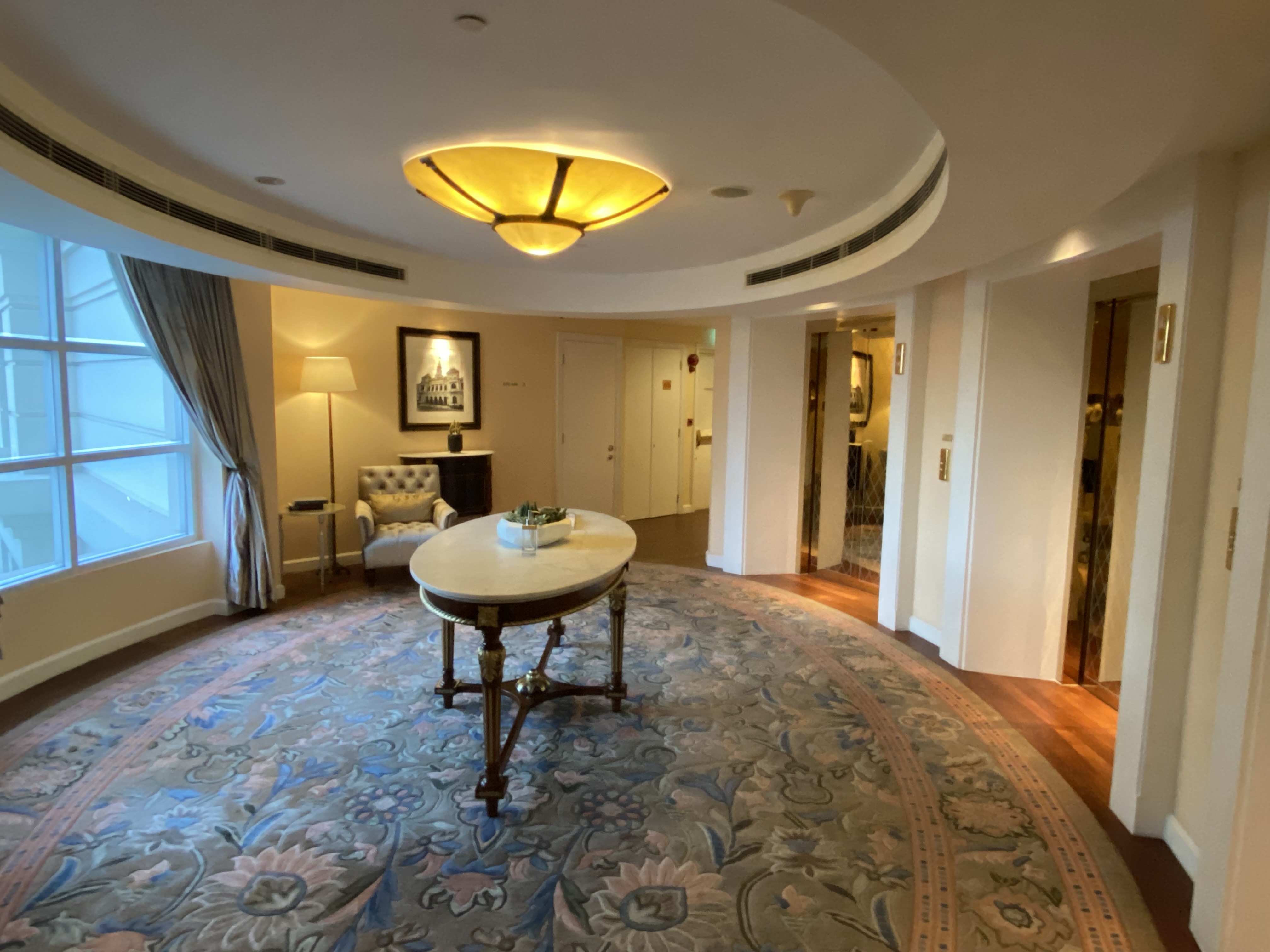 a room with a round table and a round carpet
