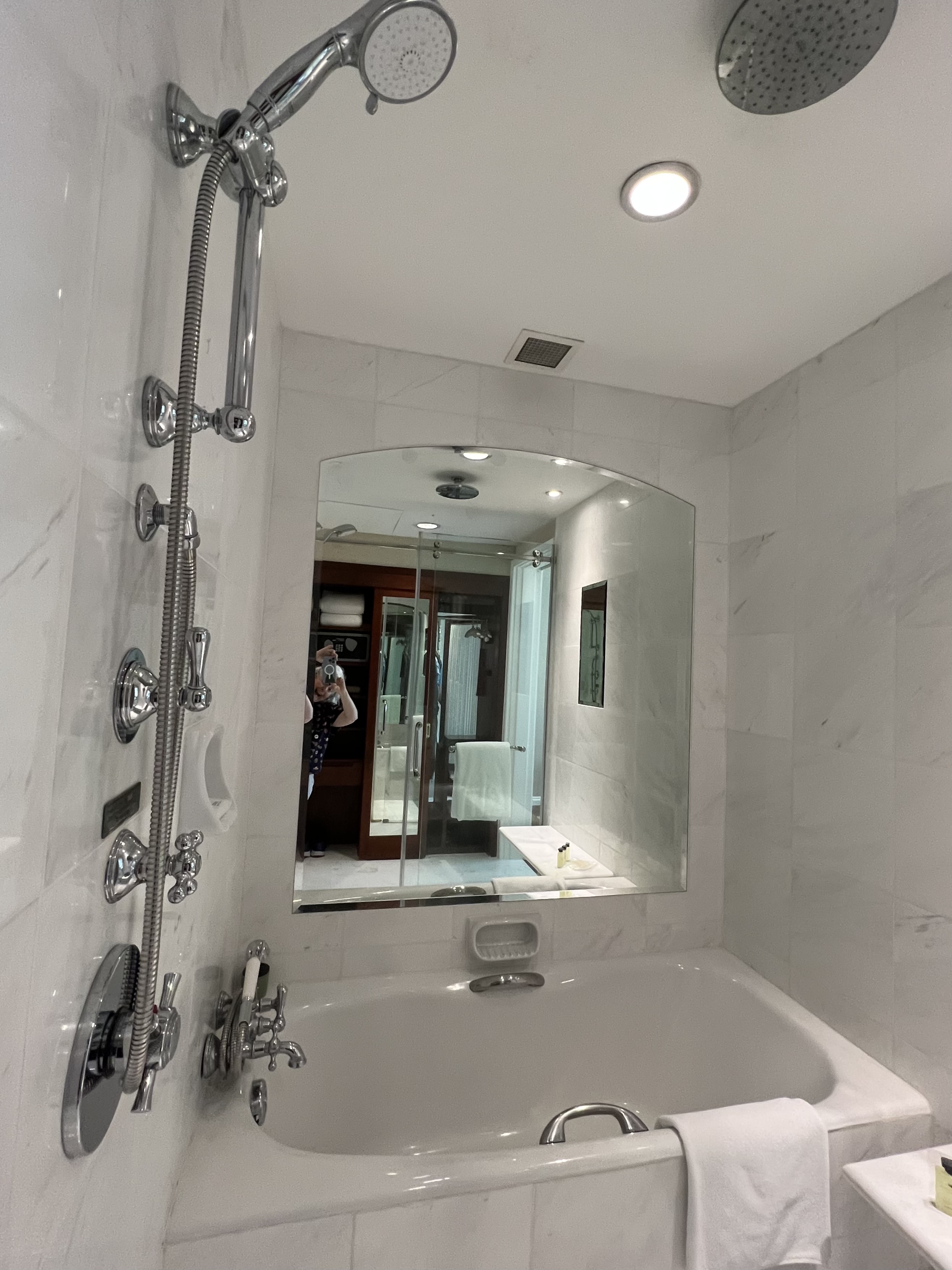 a bathroom with a mirror and tub