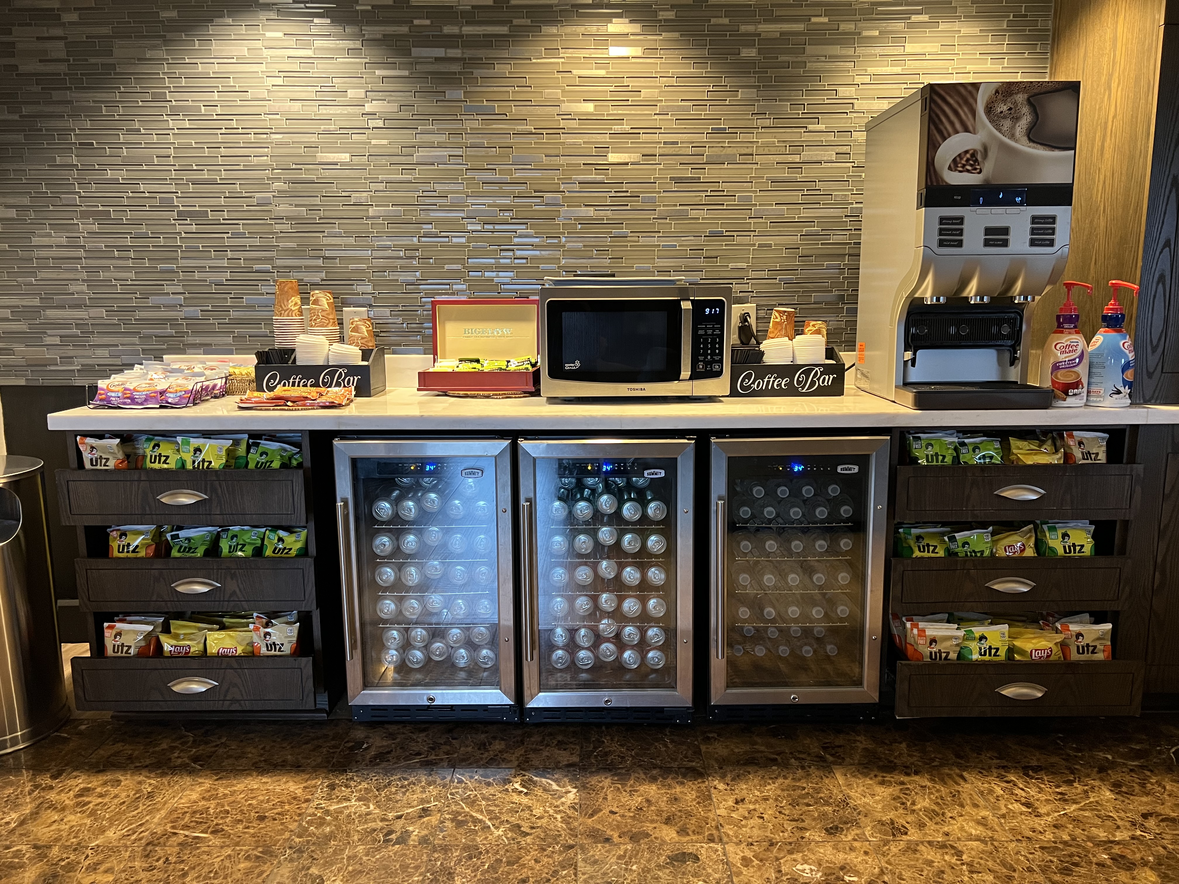 a counter with a microwave and a refrigerator