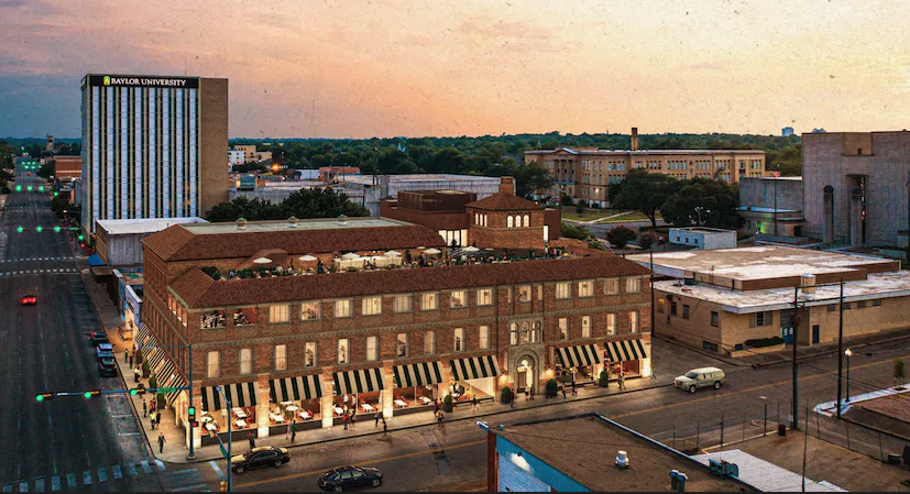 a building with many windows and a street with cars and buildings