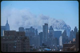 a city skyline with smoke coming out of it