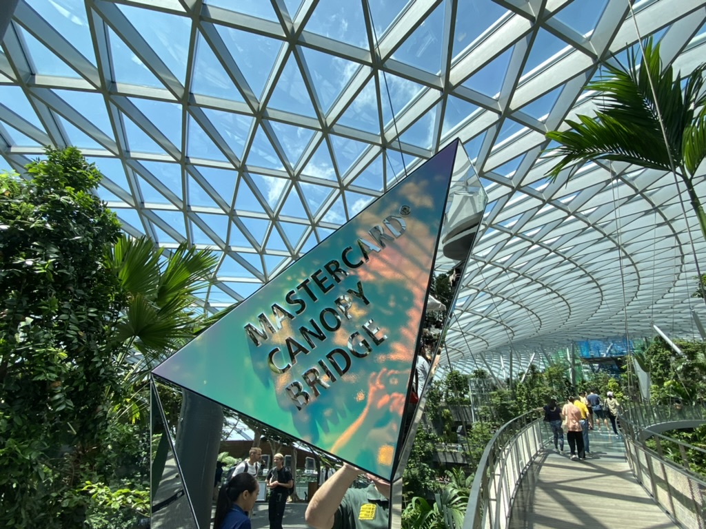 a person holding a sign in a glass dome