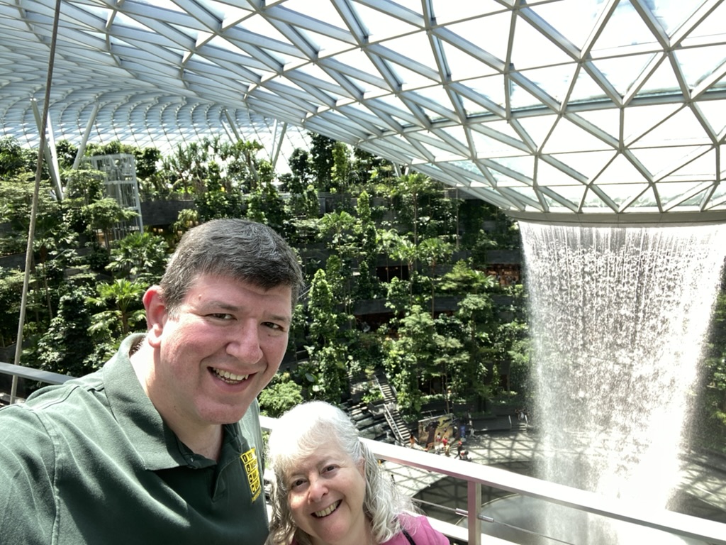 a man and woman taking a selfie in a glass dome