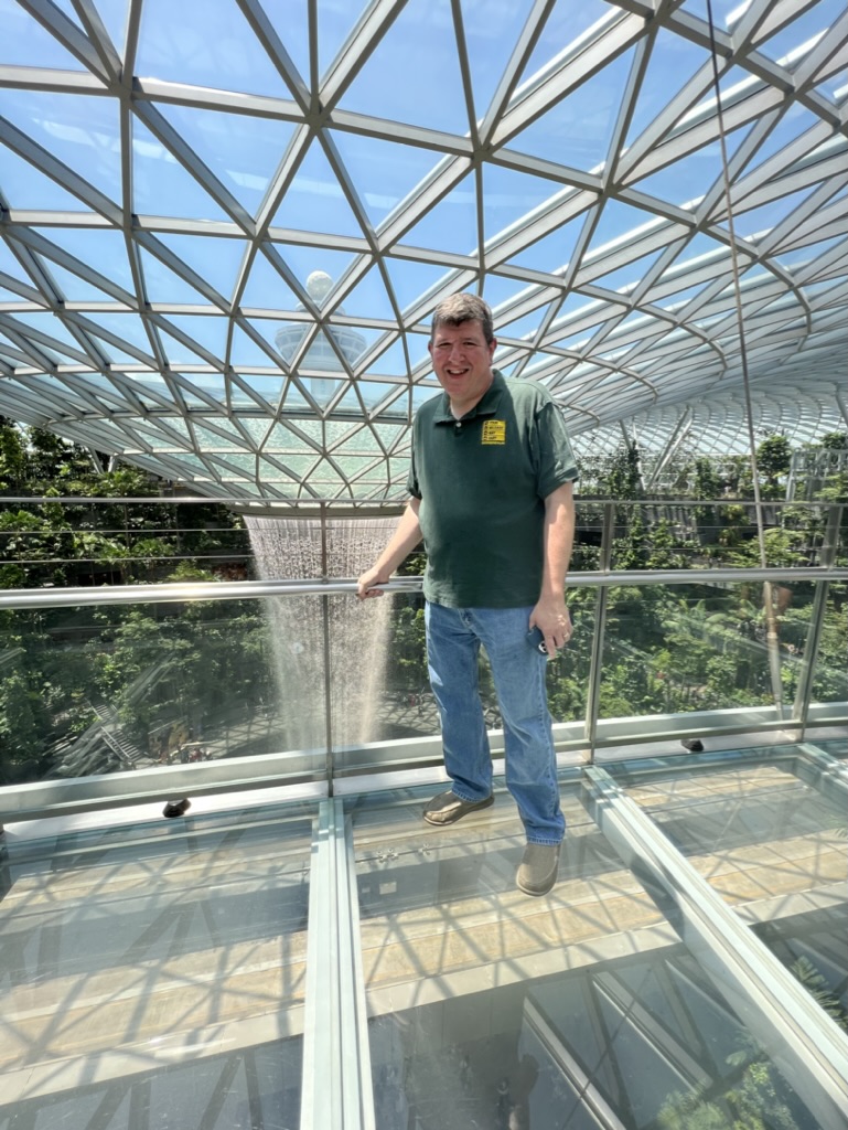 a man standing in a glass room