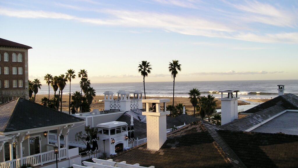 a rooftops with palm trees and a beach