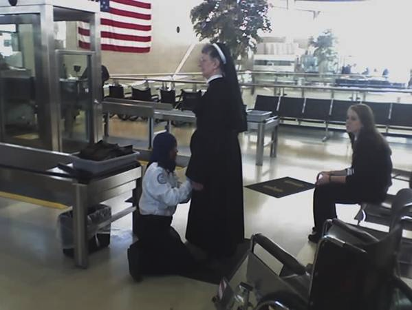 a woman kneeling on her knees with a woman kneeling on her knees