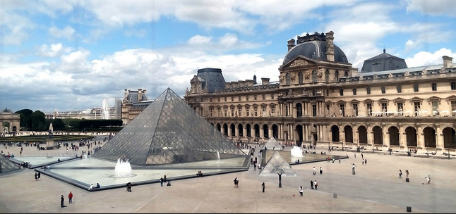 a large pyramid in front of Louvre