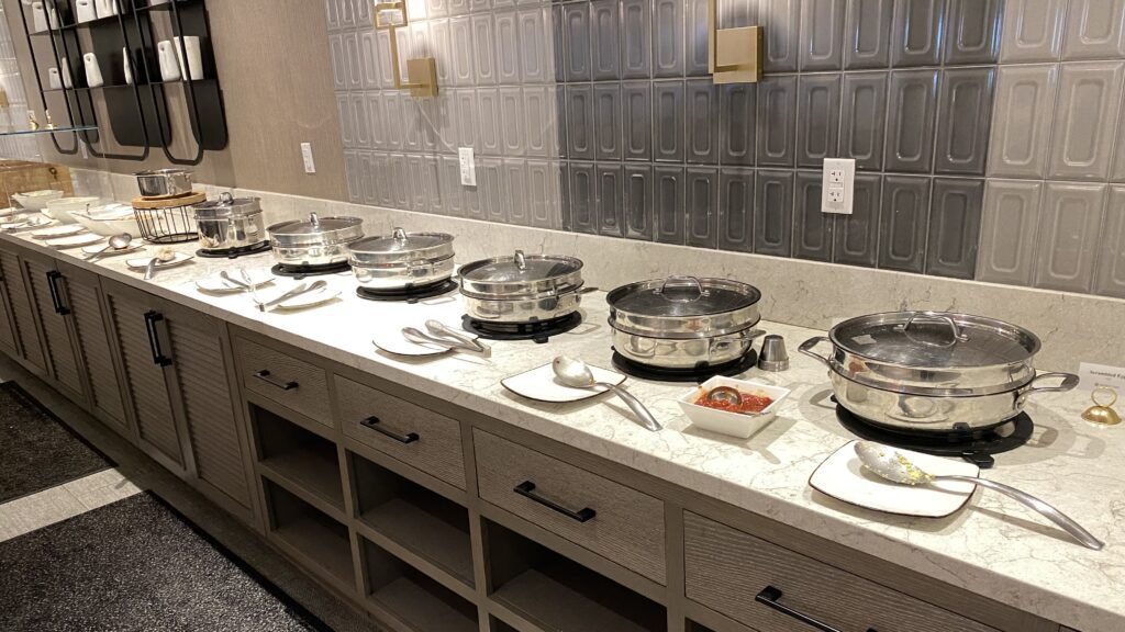 a row of silver pots on a counter