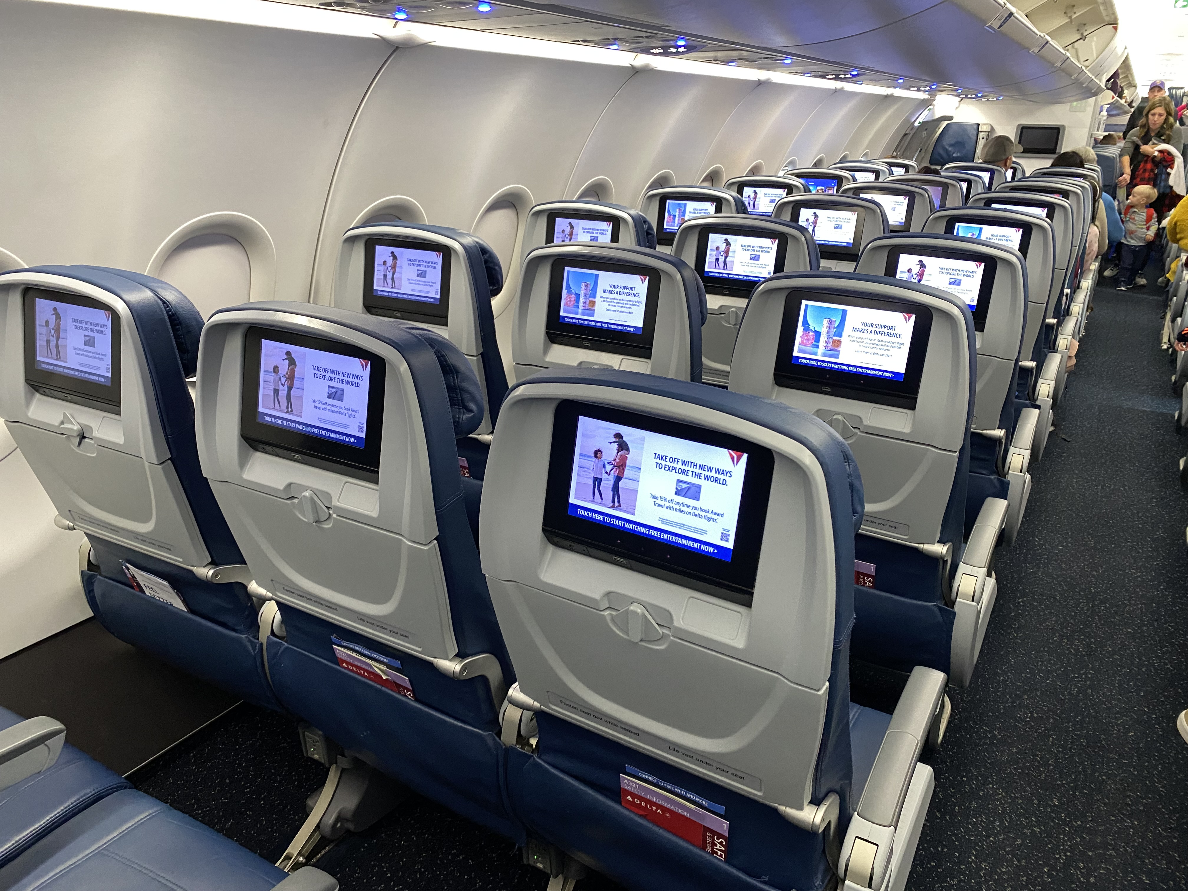 a row of seats with monitors on the back