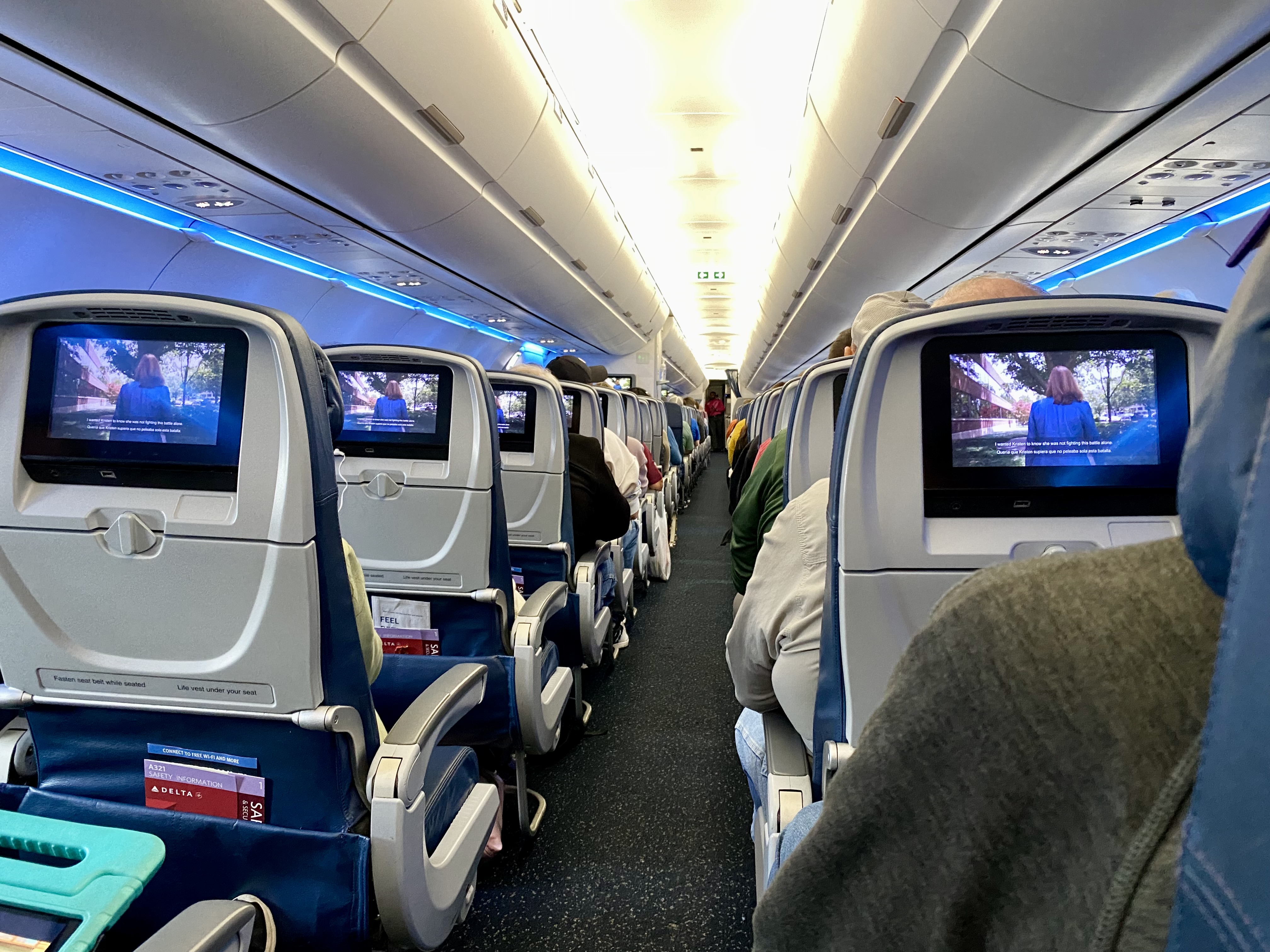 a row of seats with tvs on the back