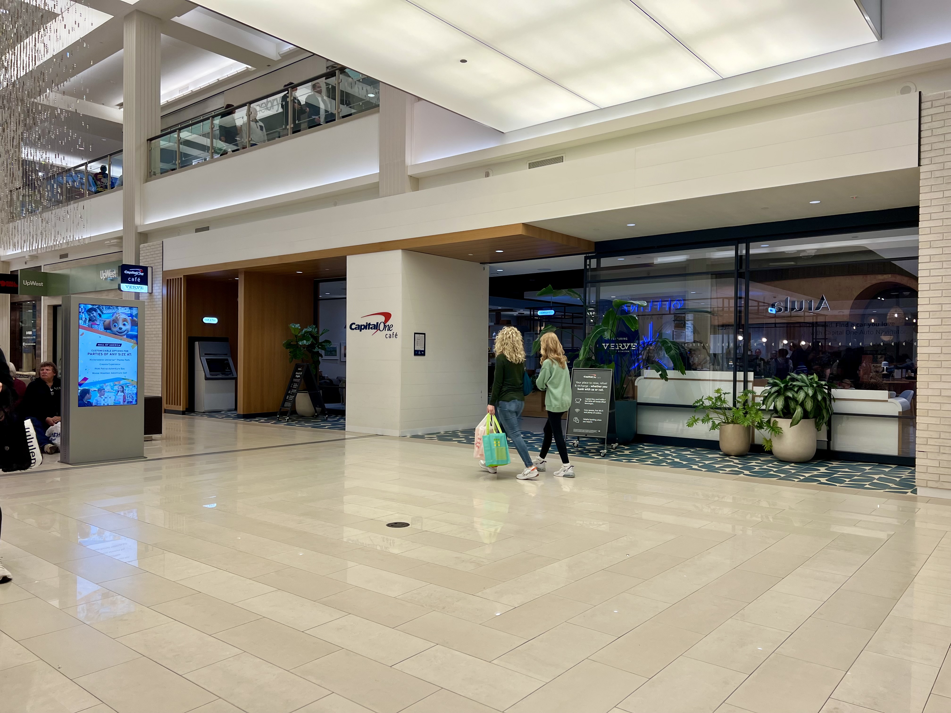 two women walking in a large building