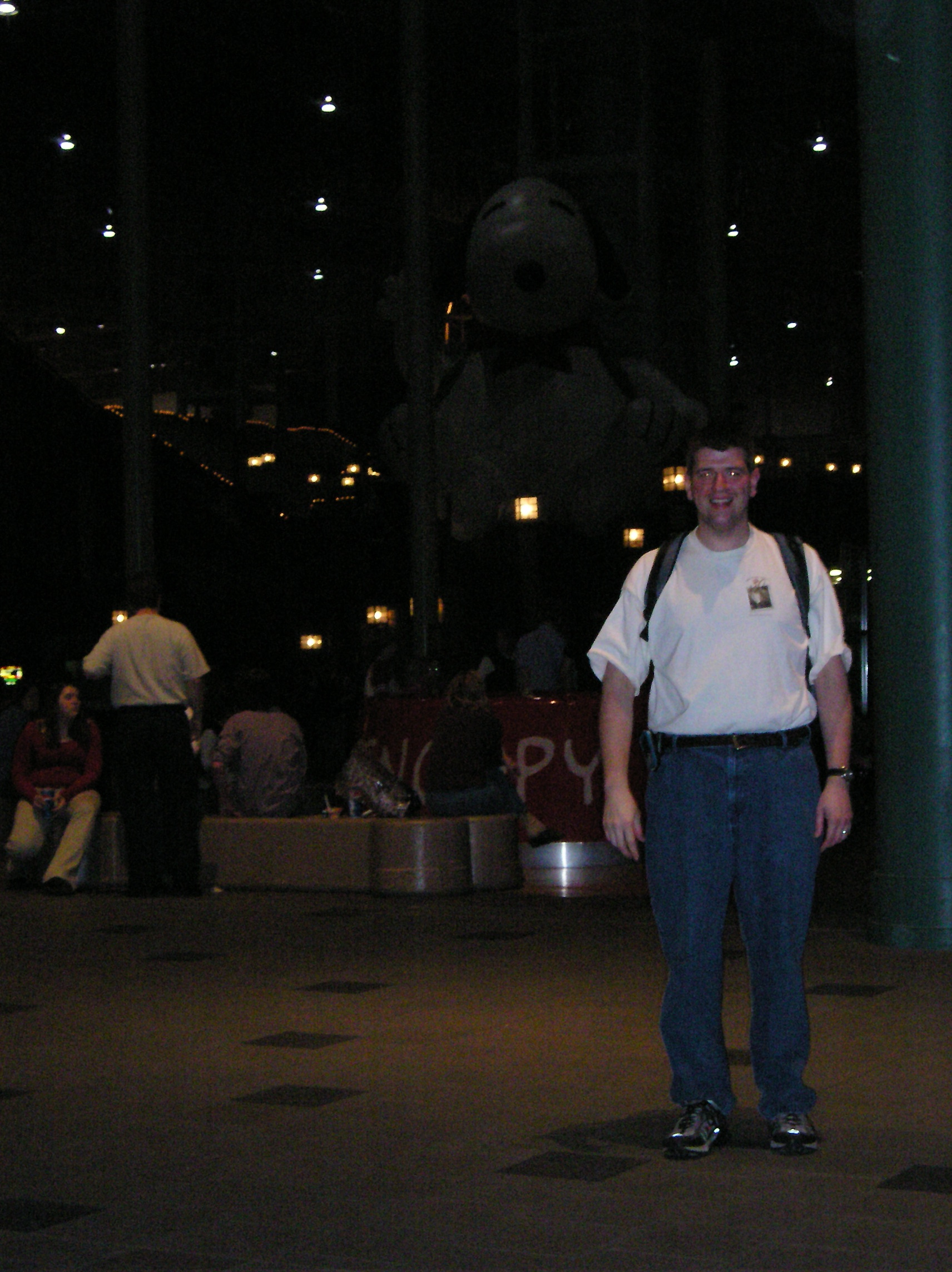 a man standing in a room with a statue of a dog