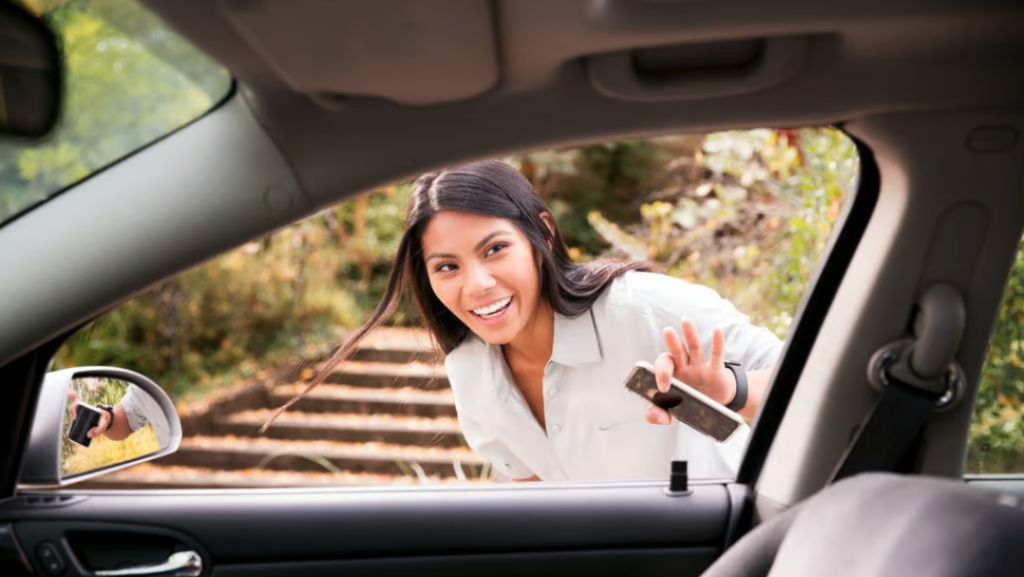 a woman smiling and holding a cellphone