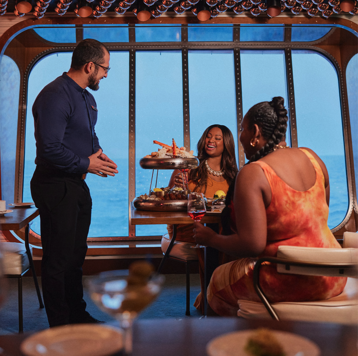 a group of people sitting at a table with food on it