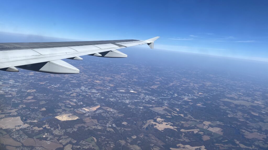 an airplane wing above the earth